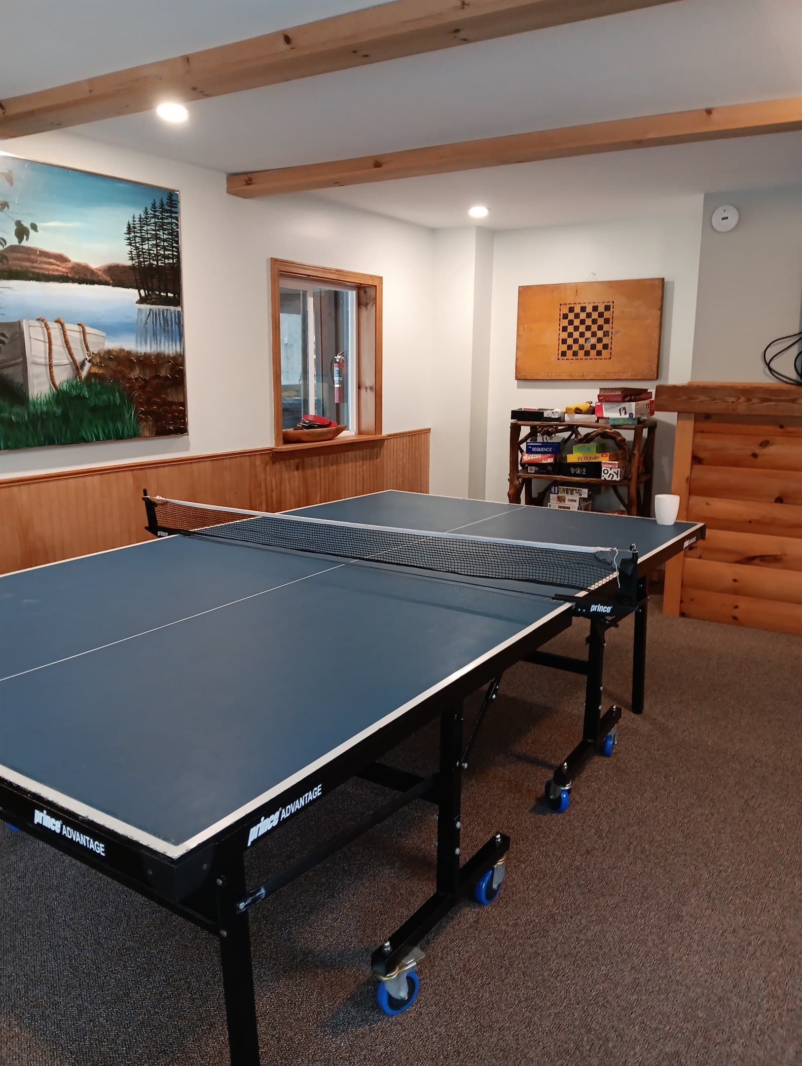 Ping-pong table beside wood cabinetry