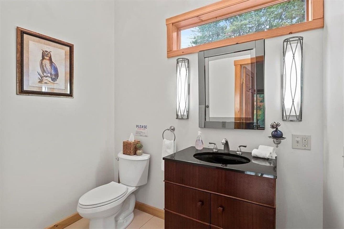 Bathroom with a dark wood vanity and toilet
