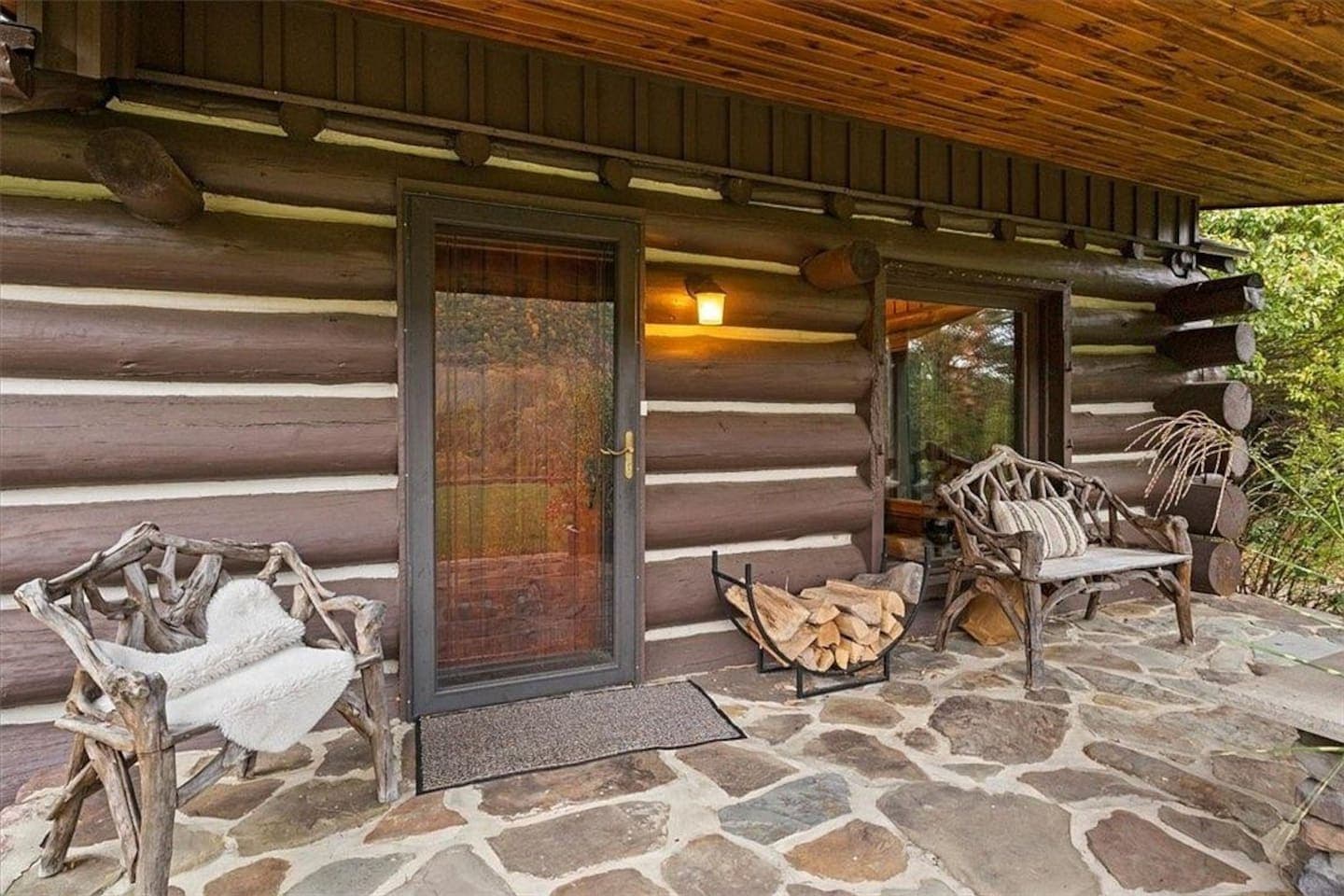 Covered log porch with outdoor seating
