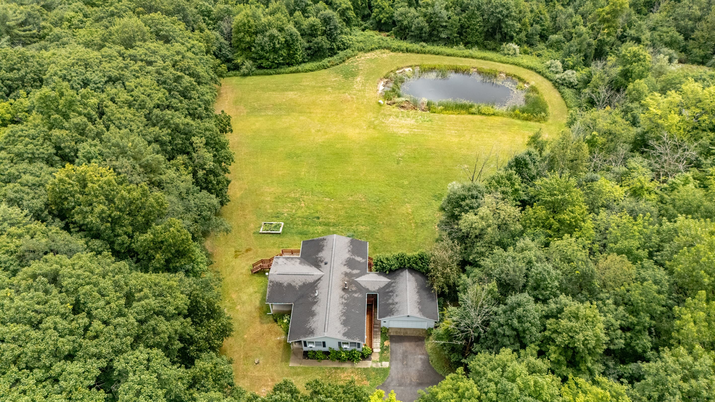 Aerial view of home and pond