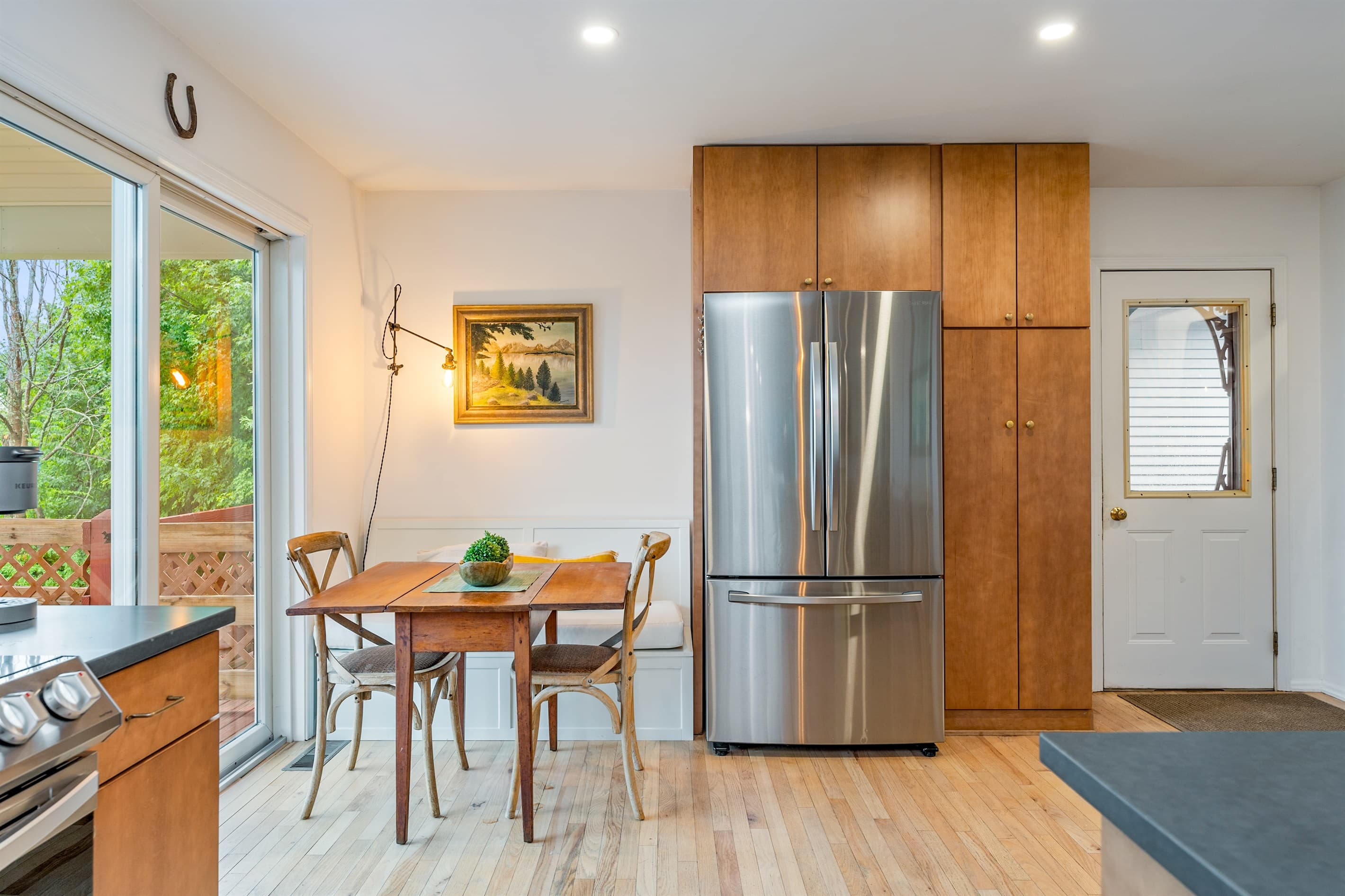 Dining nook beside stainless steel refrigerator