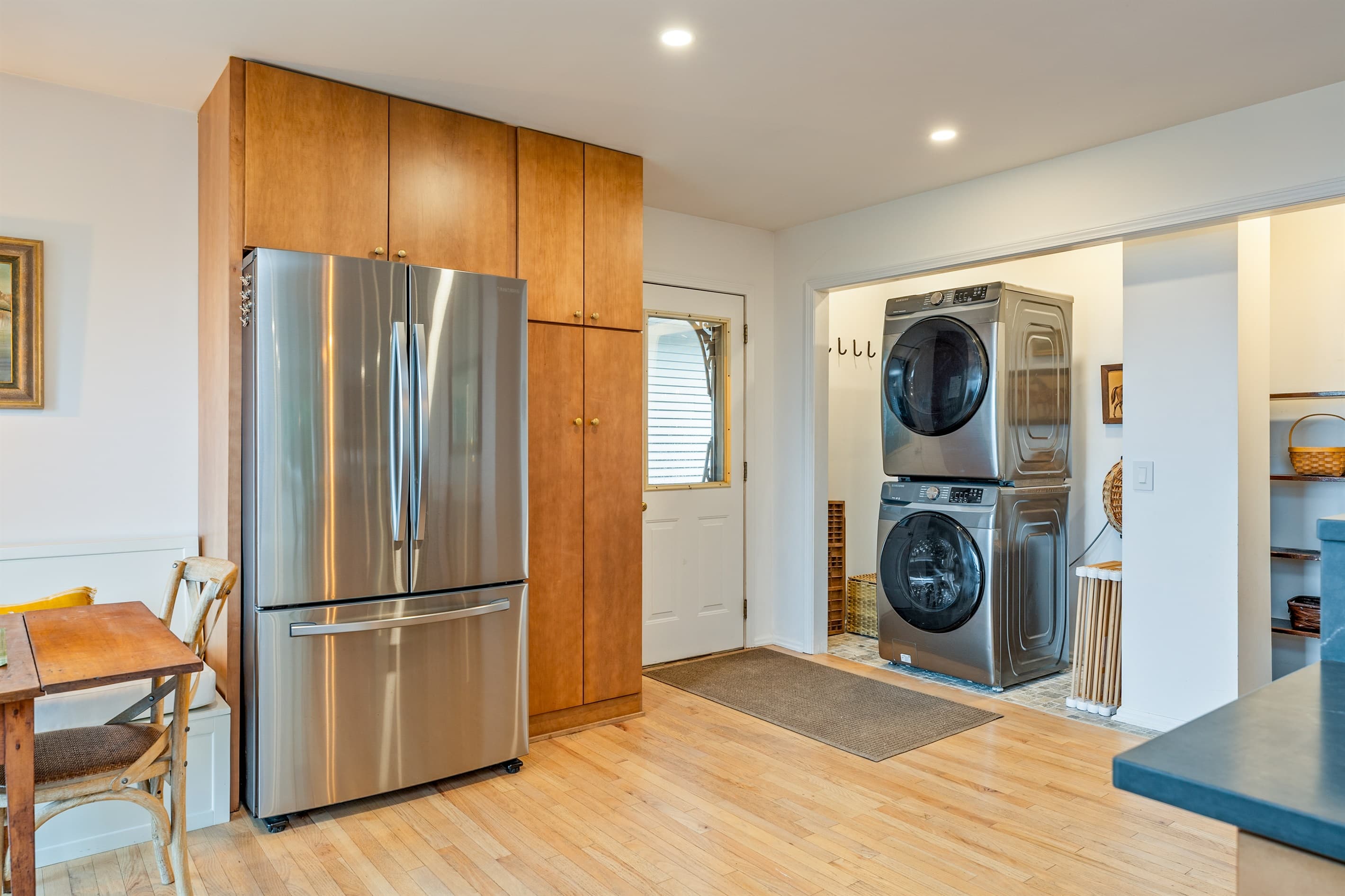 Laundry appliances beside stainless steel refrigerator