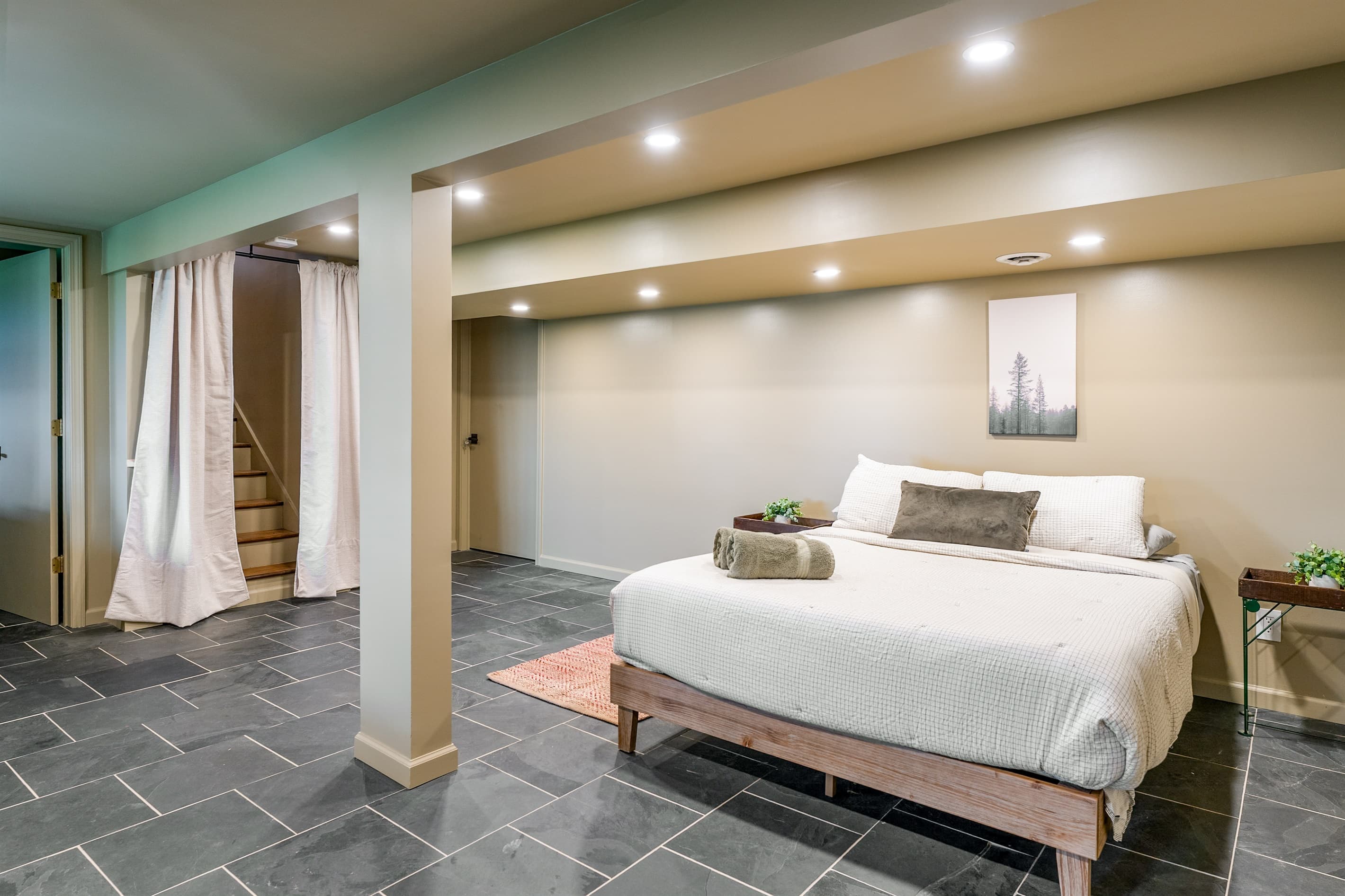 Bed beneath recessed ceiling lights
