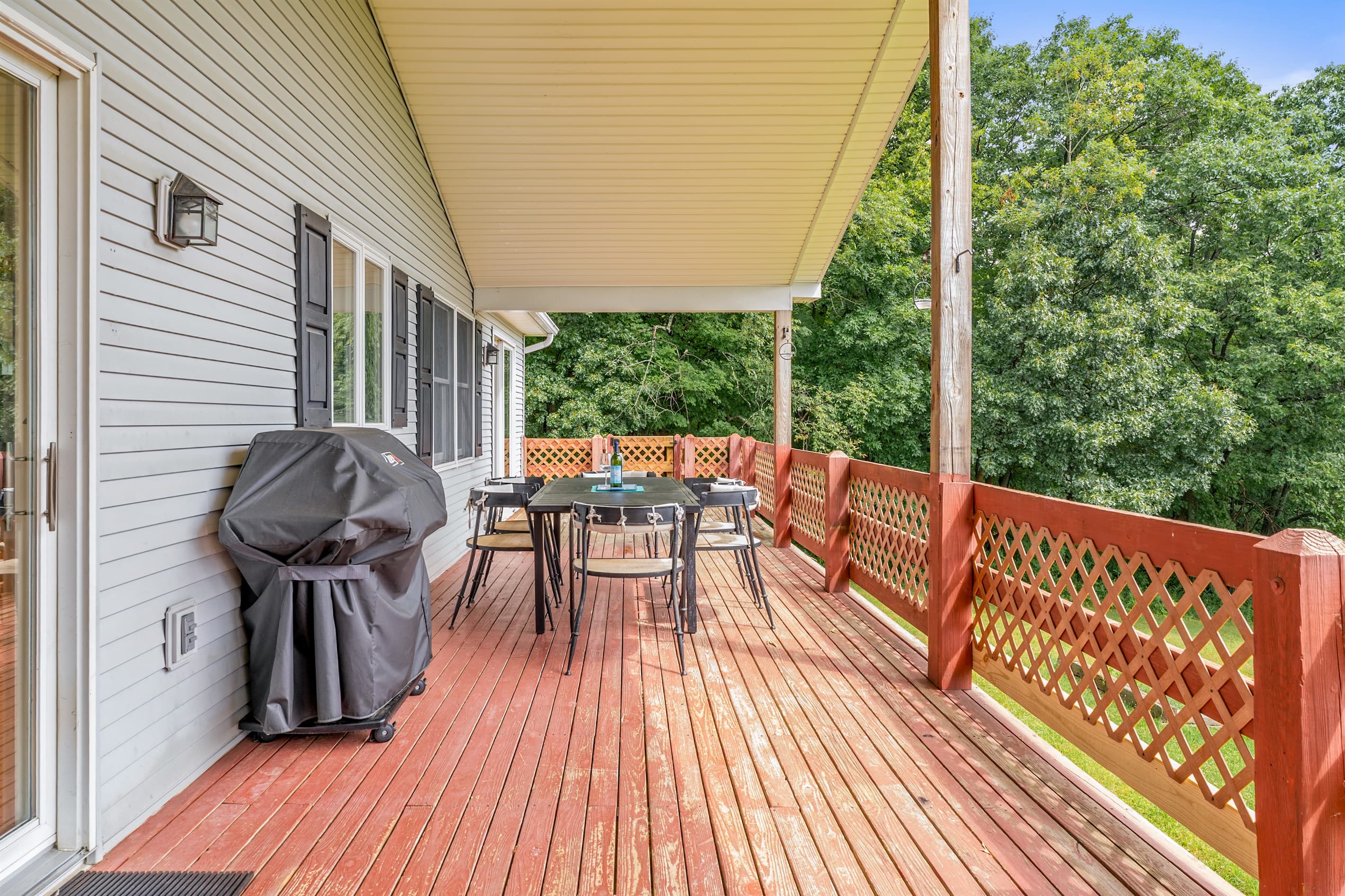 Covered deck with grill and outdoor seating
