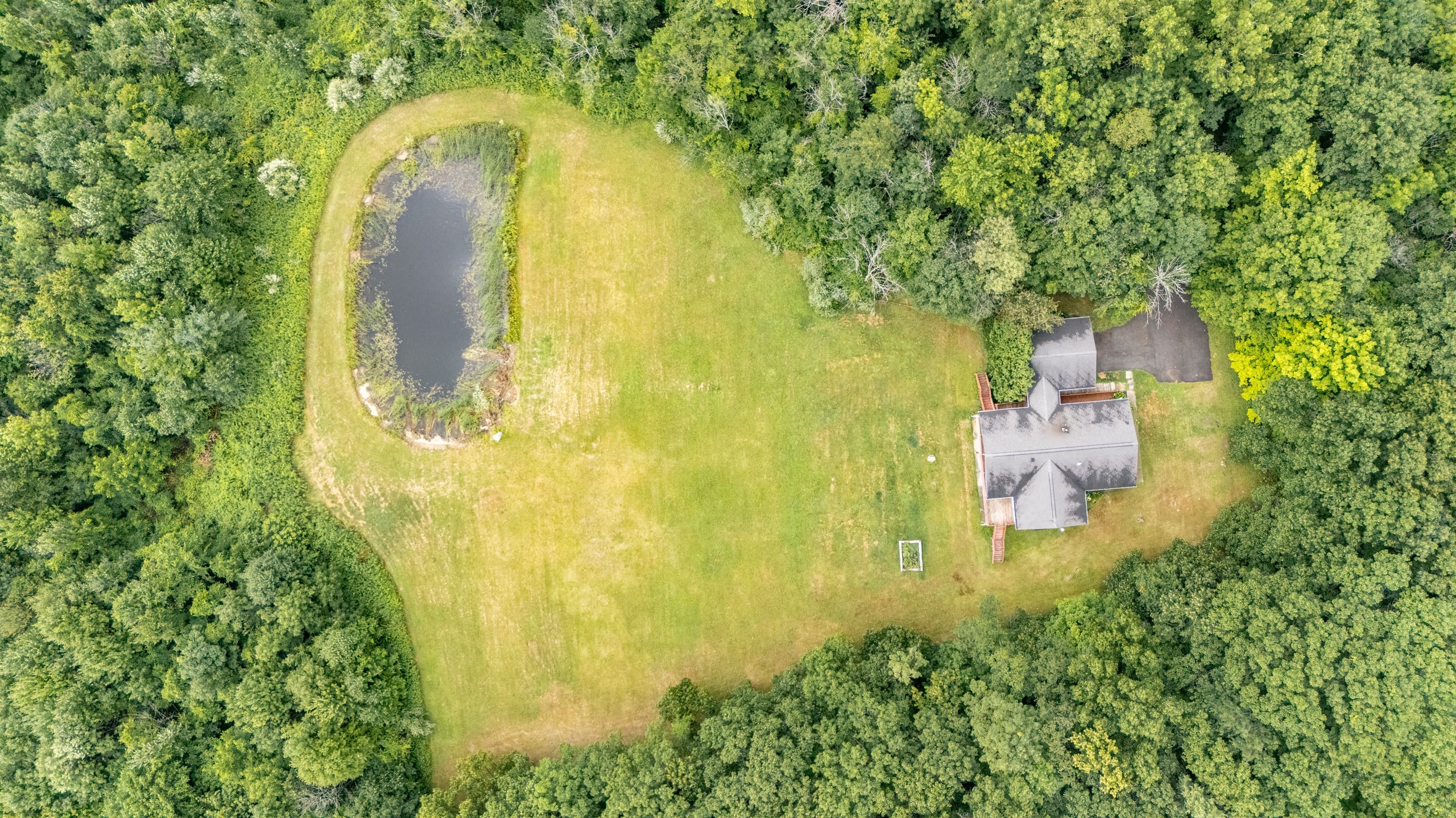 Aerial view of house and pond