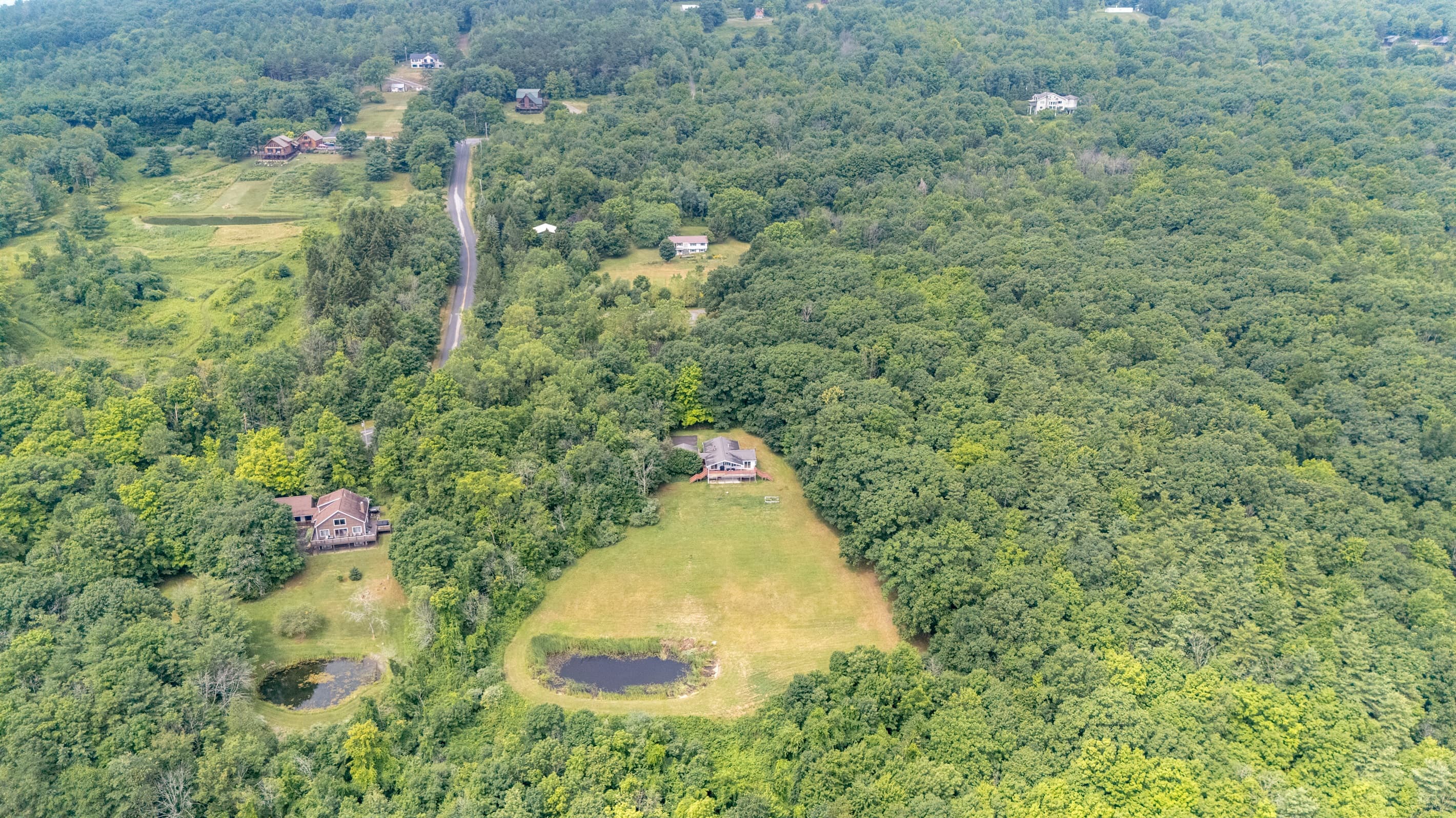 Wooded hills surrounding scattered homes
