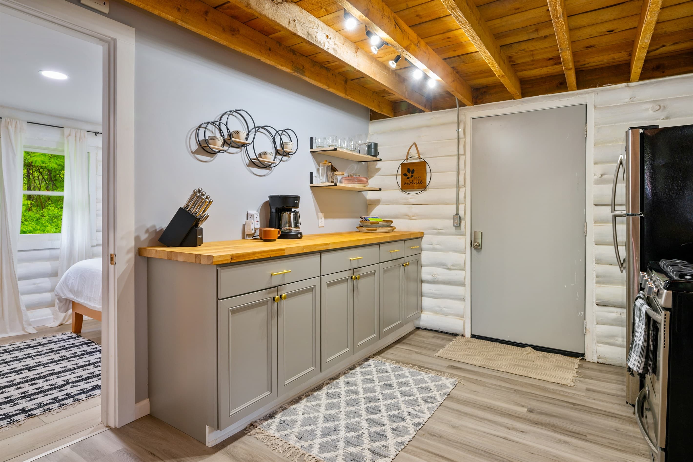 Kitchen beneath exposed wood ceilings