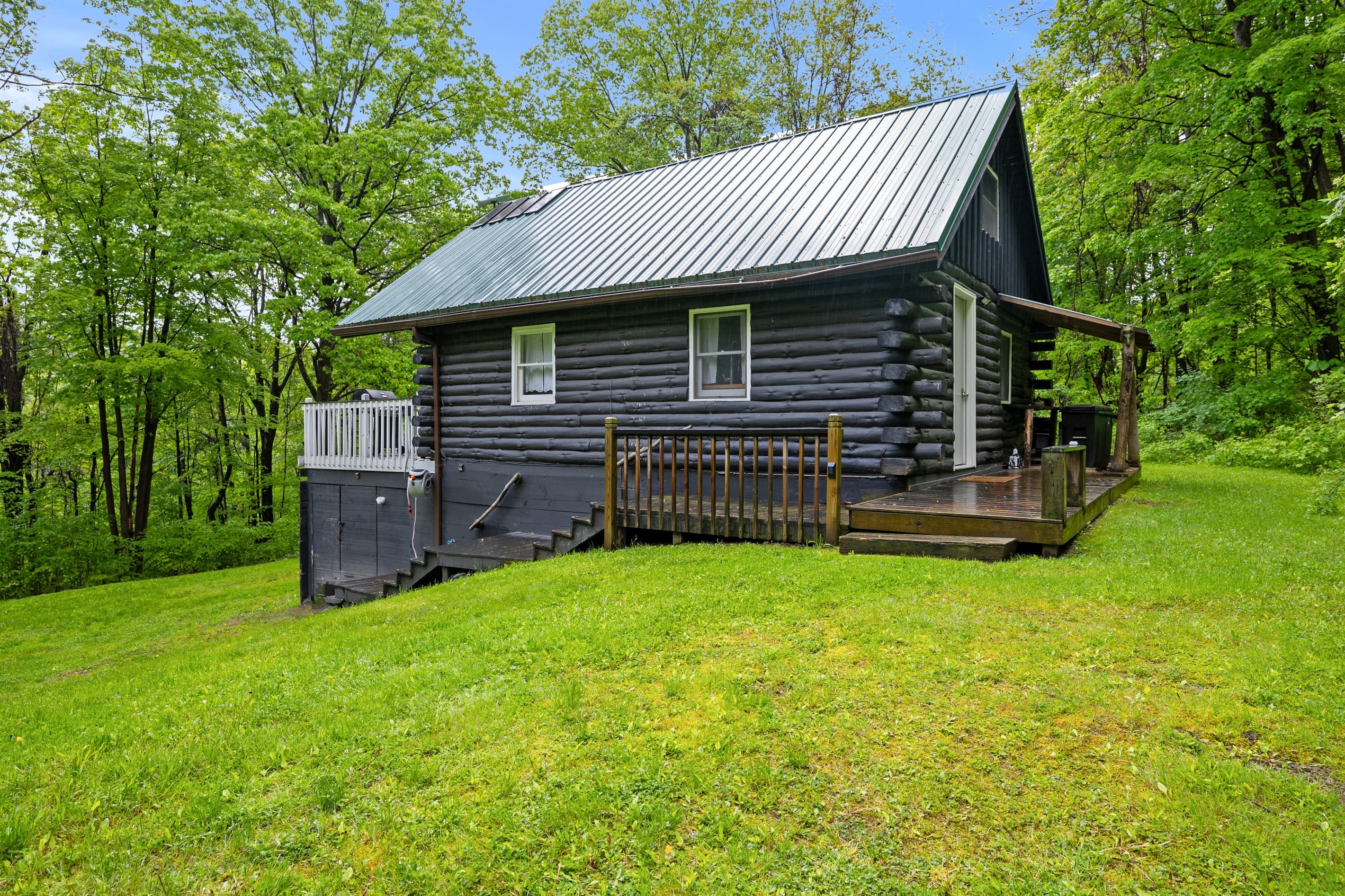 Side exterior with raised wooden deck