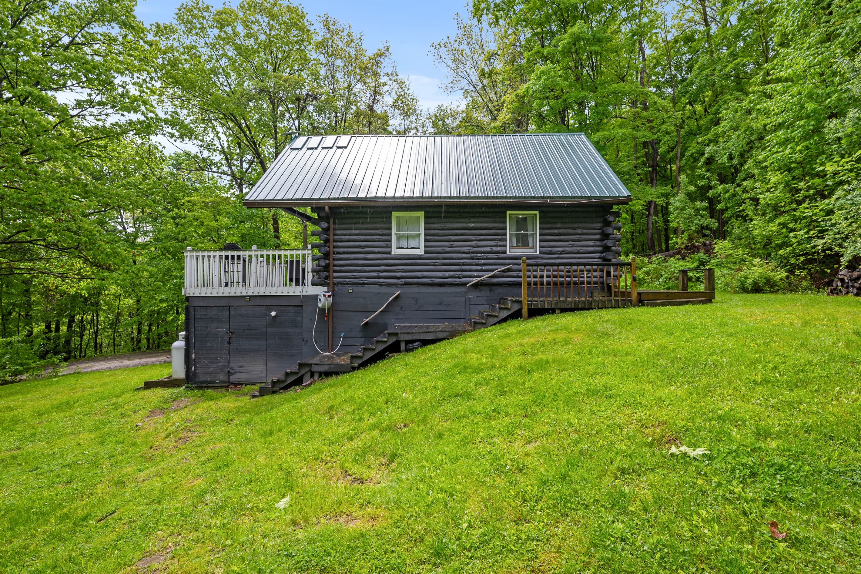 Log cabin exterior across the lawn