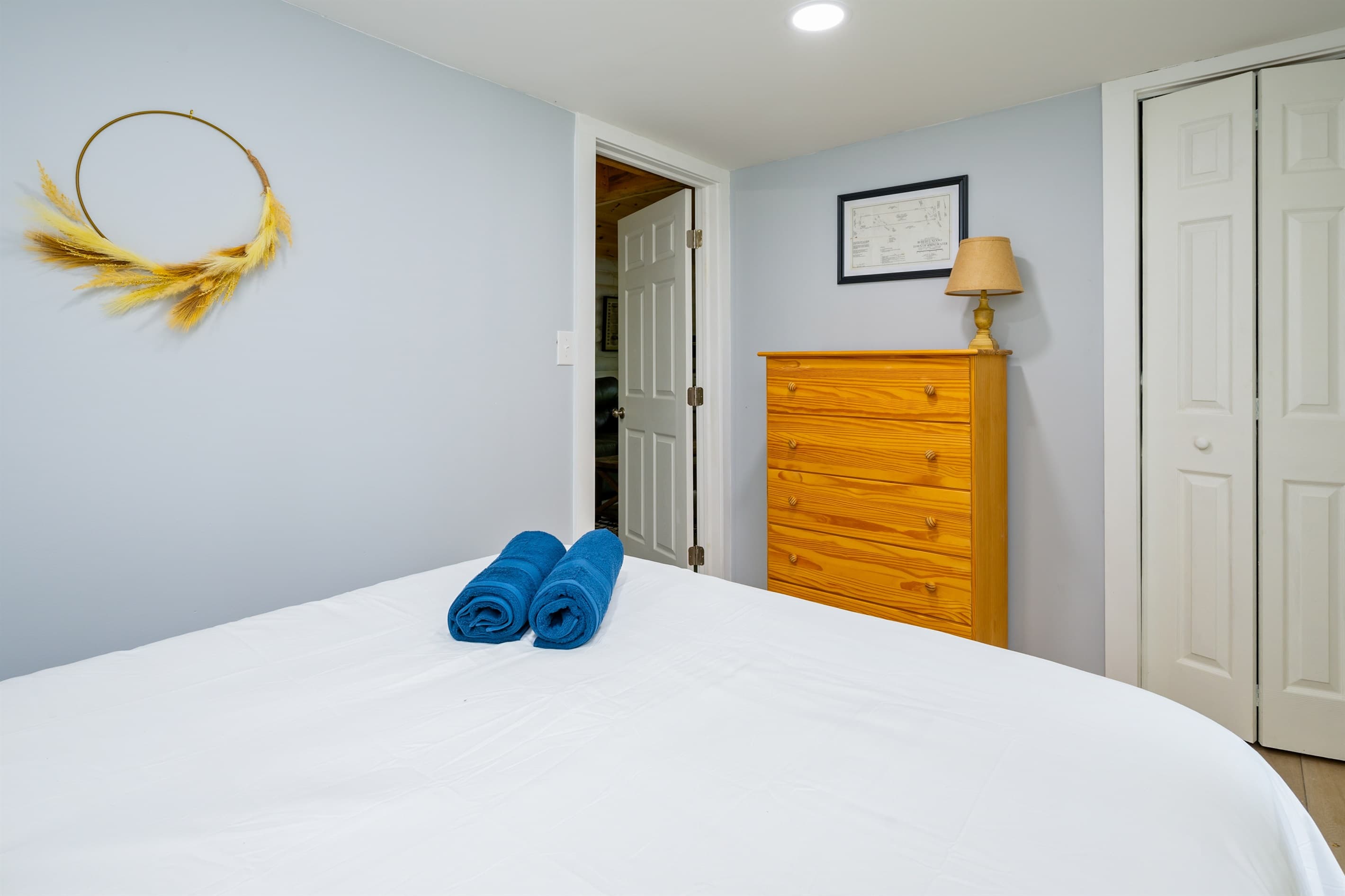 Bedroom with wood dresser and wall mirror