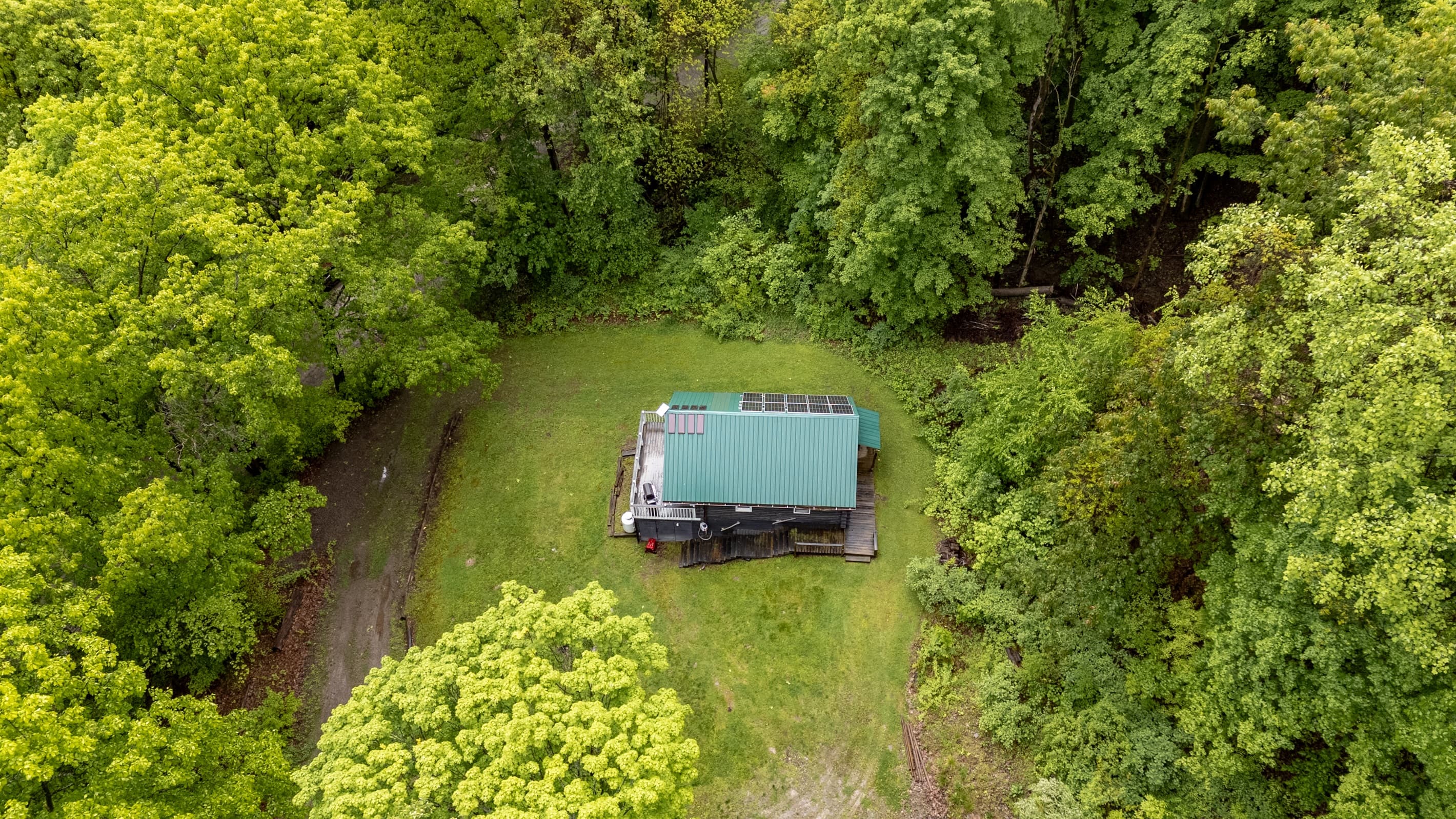 Overhead view of cabin and surrounding forest