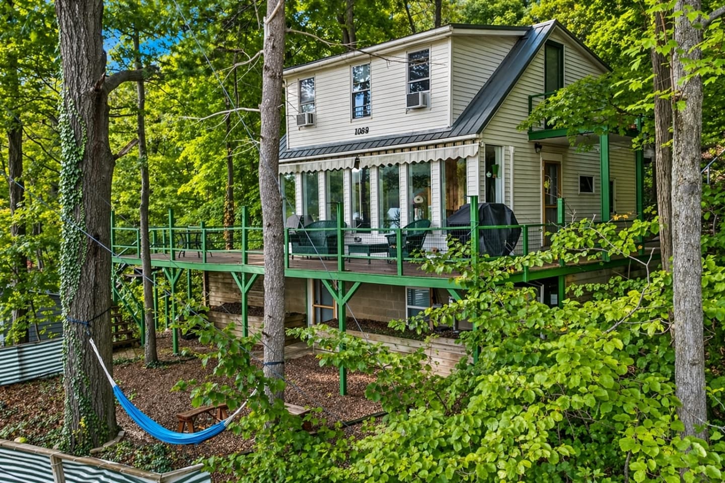 Two-story home surrounded by mature trees