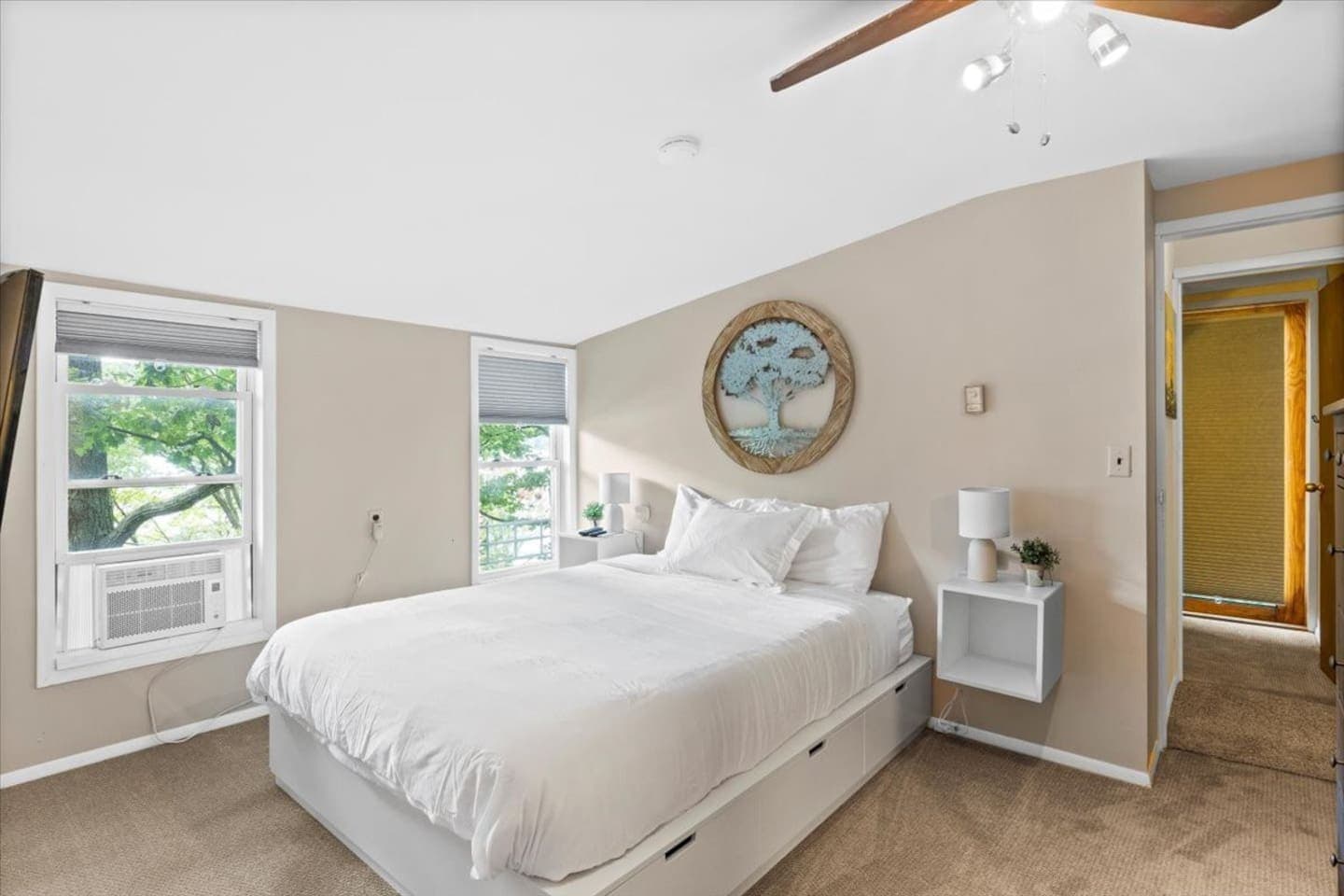 Bed positioned in the middle of floating nightstands