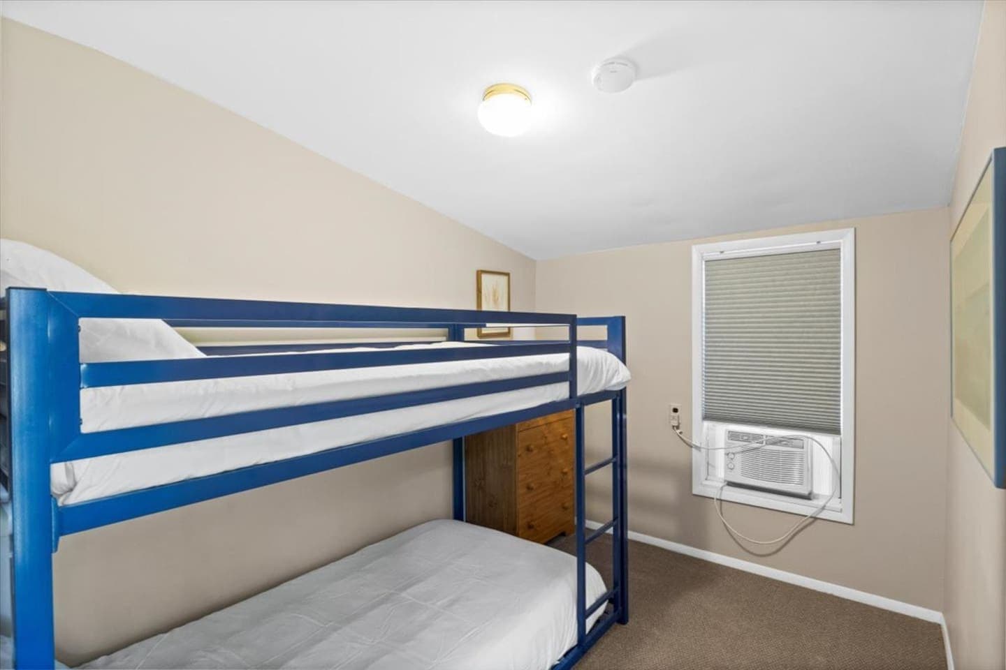 Blue metal bunk bed near window