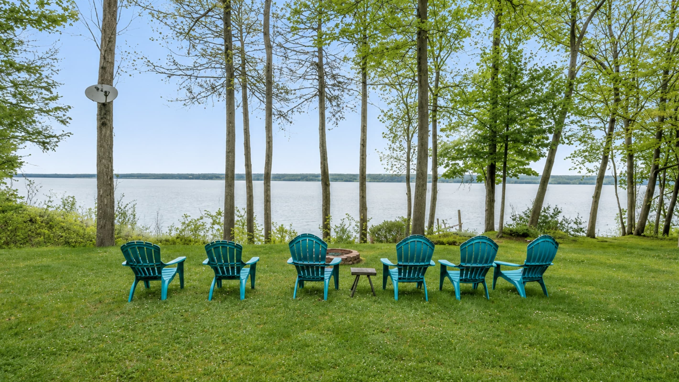 Adirondack chairs positioned along the shoreline