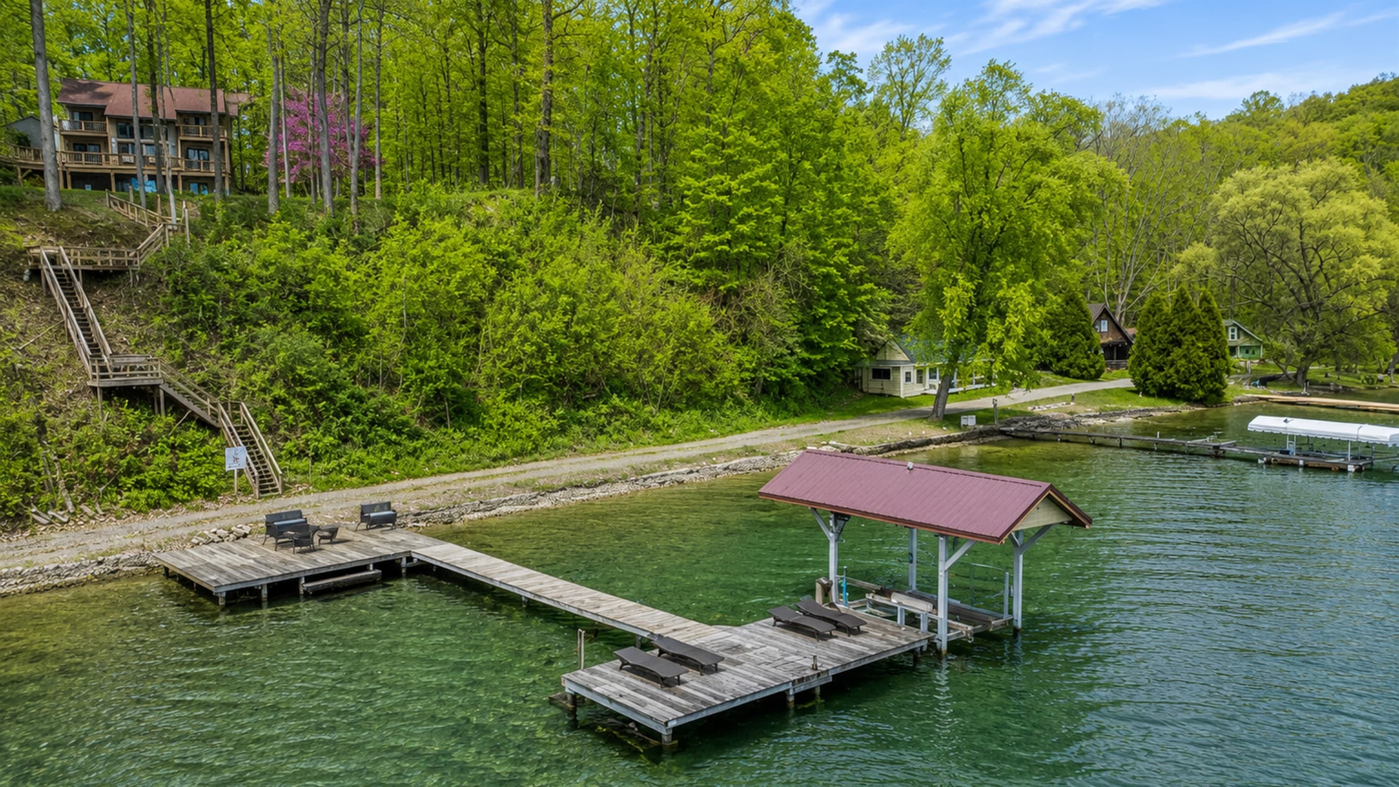 Private dock extending from the wooded shoreline