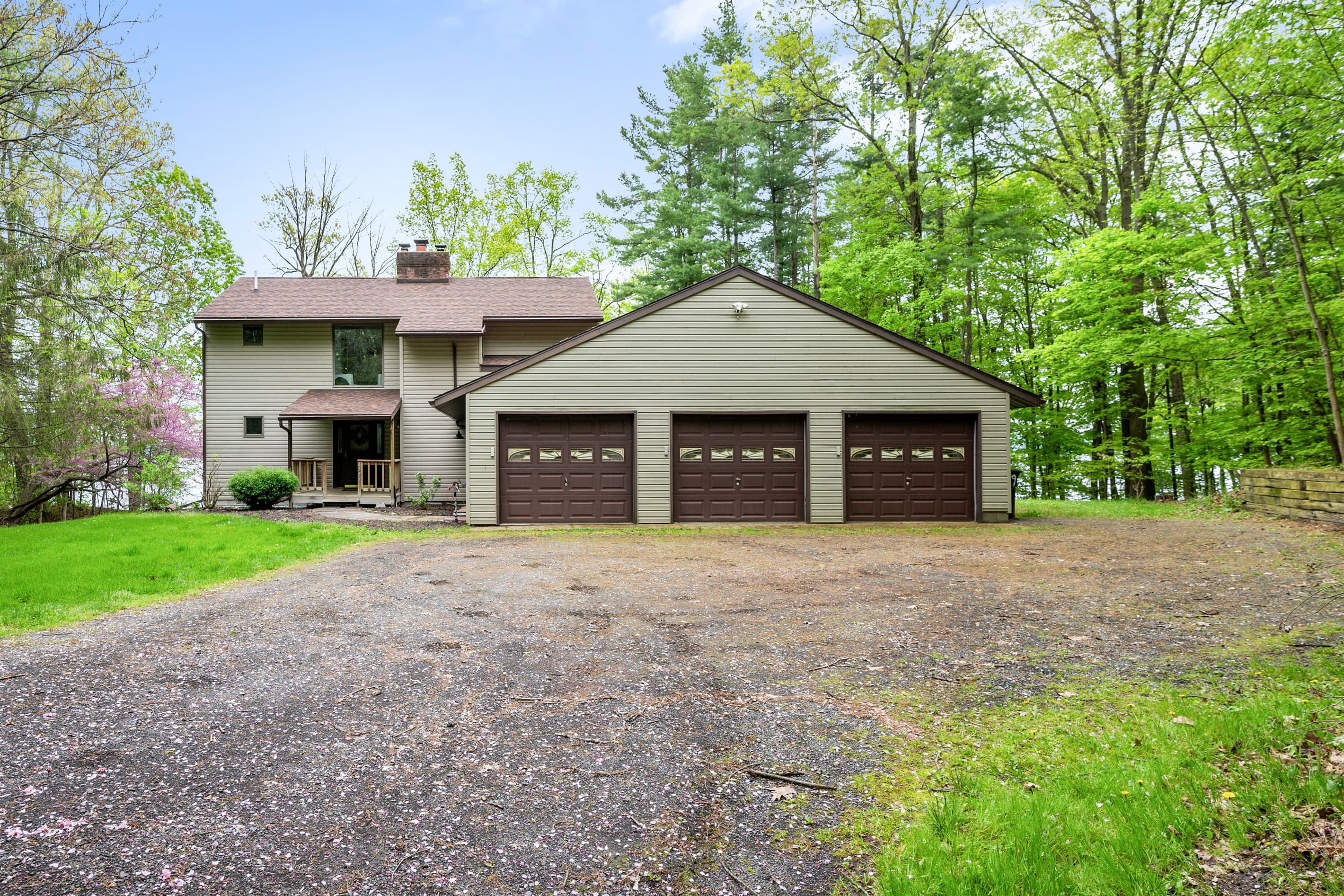 Three-car garage surrounded by mature trees