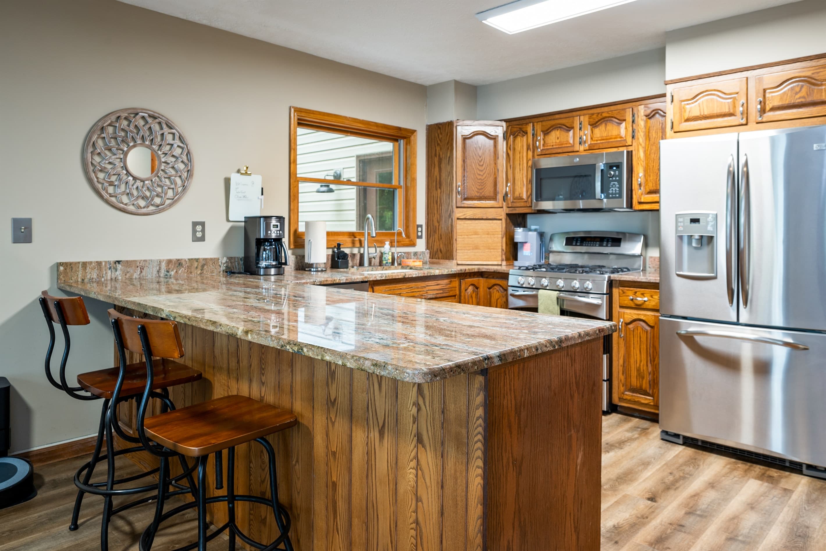Kitchen with granite peninsula and bar seating