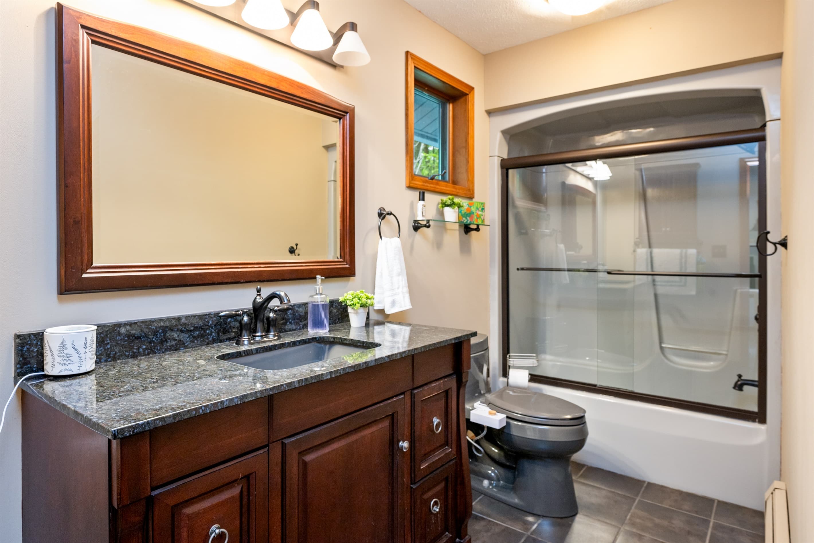 Bathroom vanity beside glass-enclosed shower