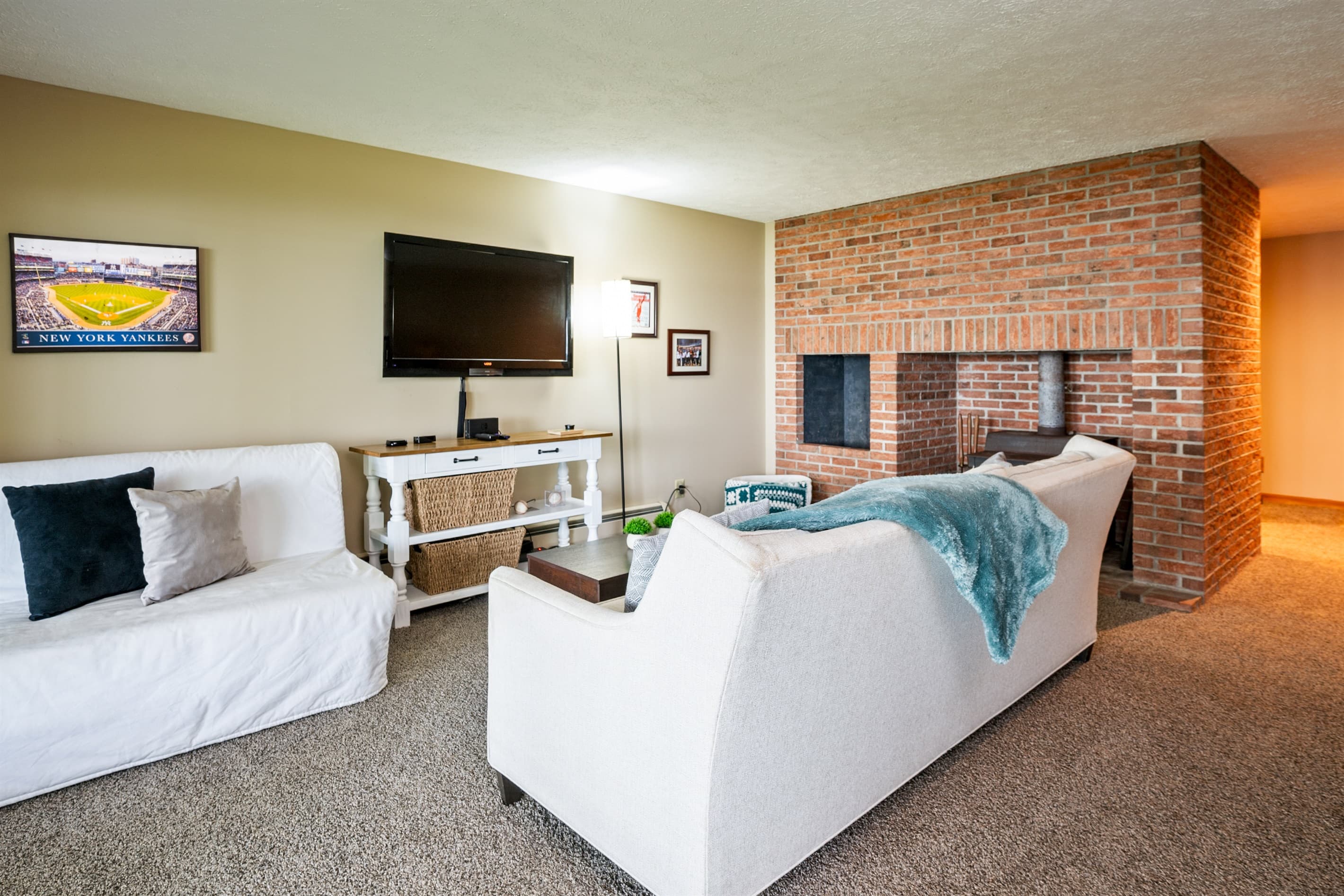 Lower living room with brick fireplace