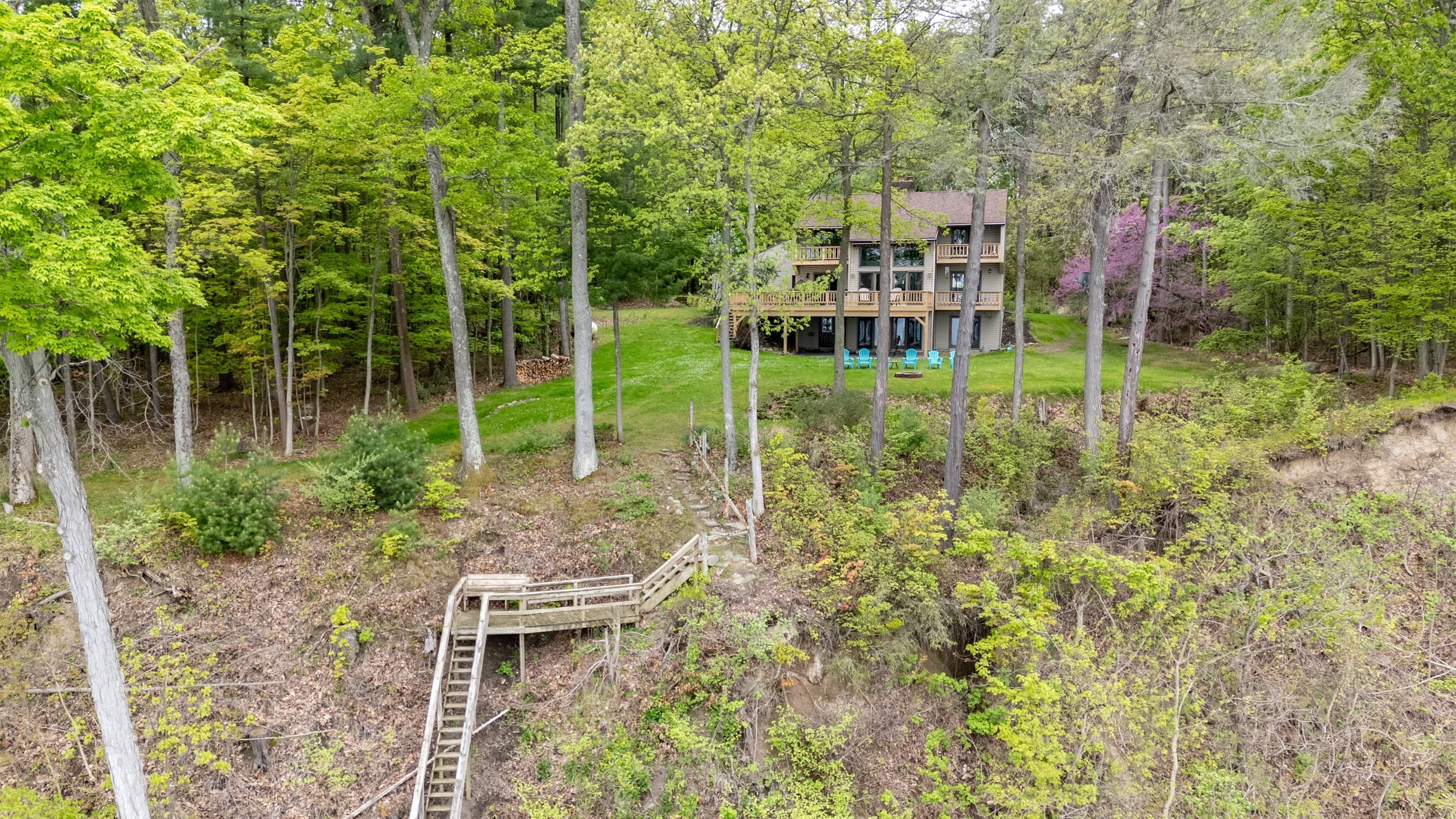Lakefront home framed by mature woodland