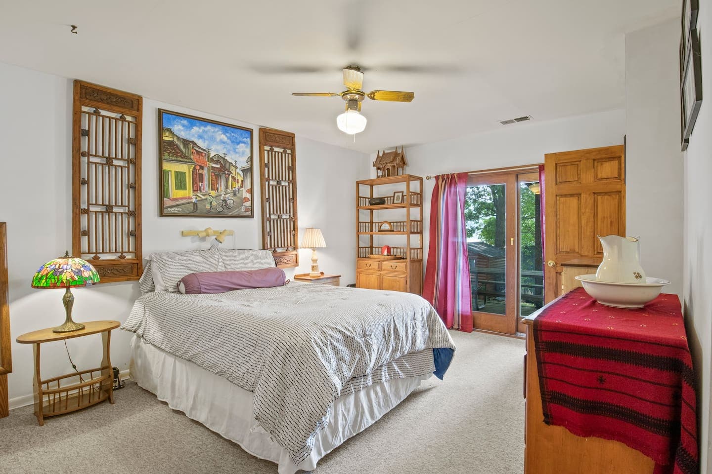 Bedroom with multiple beds and wood furniture