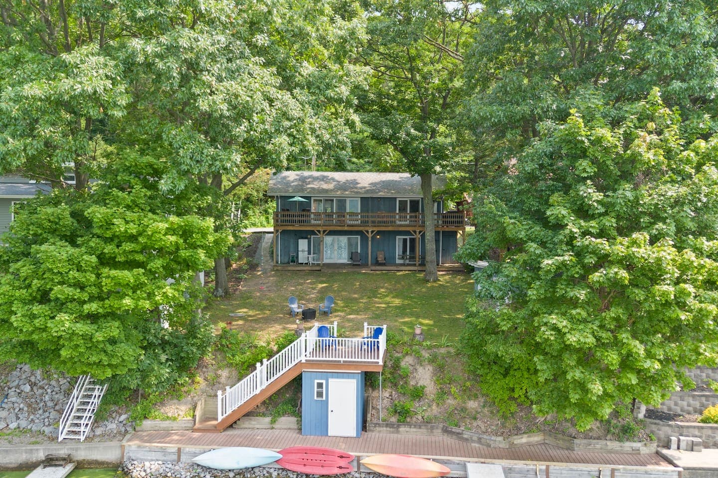 Cottage exterior framed by dense foliage