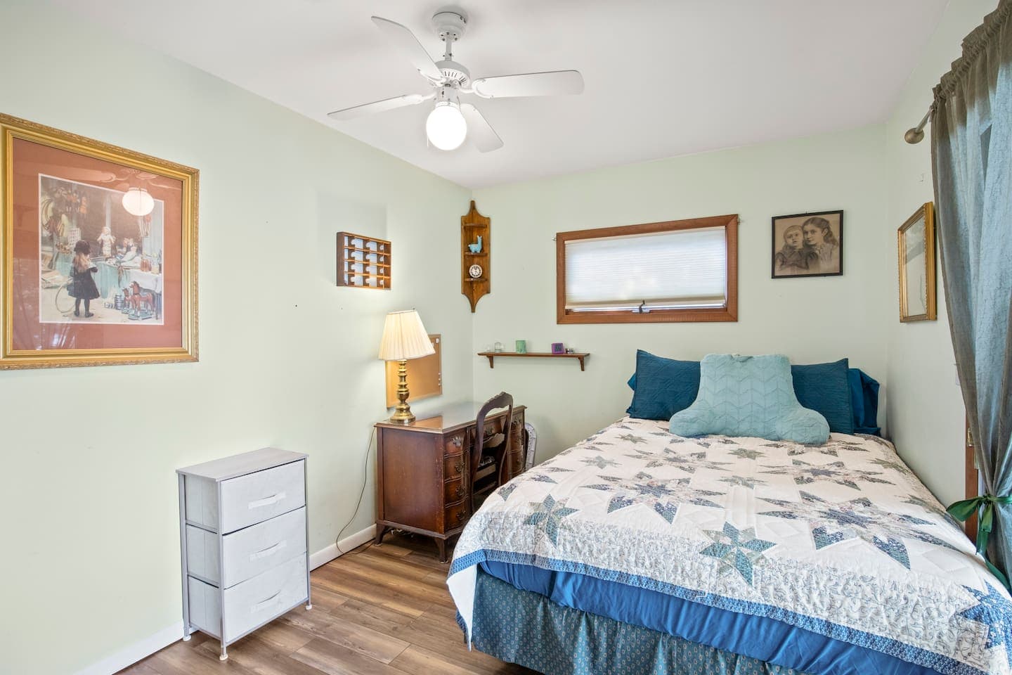 Bedroom with floral bedding and wood furniture