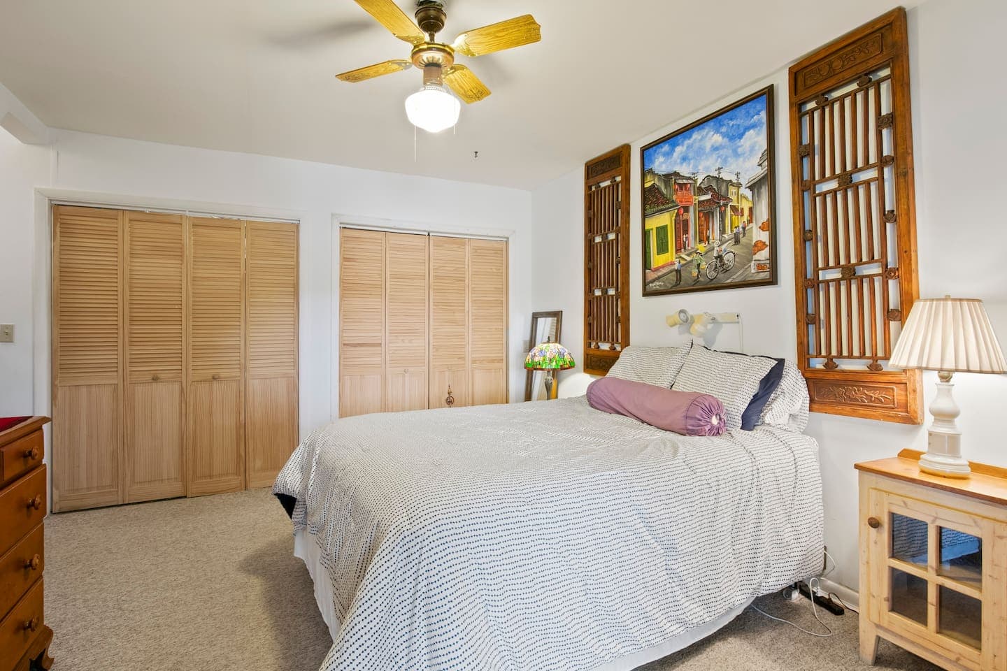 Bedroom with multiple beds and ceiling fan