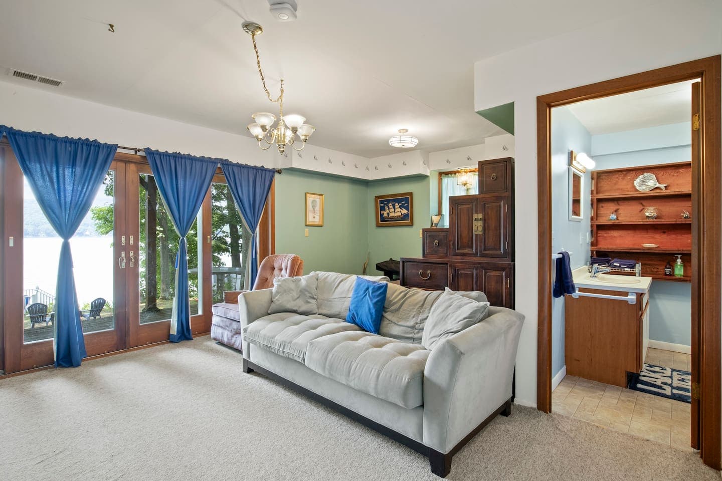 Living room with blue curtains and ceiling fan