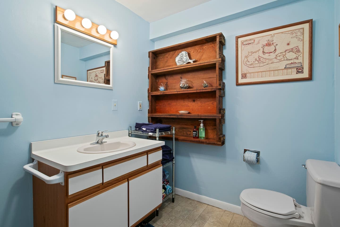Bathroom with wood dresser and framed artwork