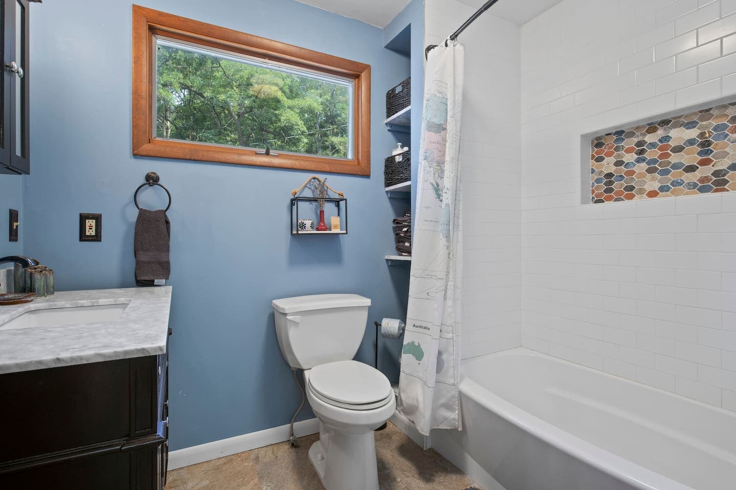 Bathroom with walk-in shower and wood-framed mirror