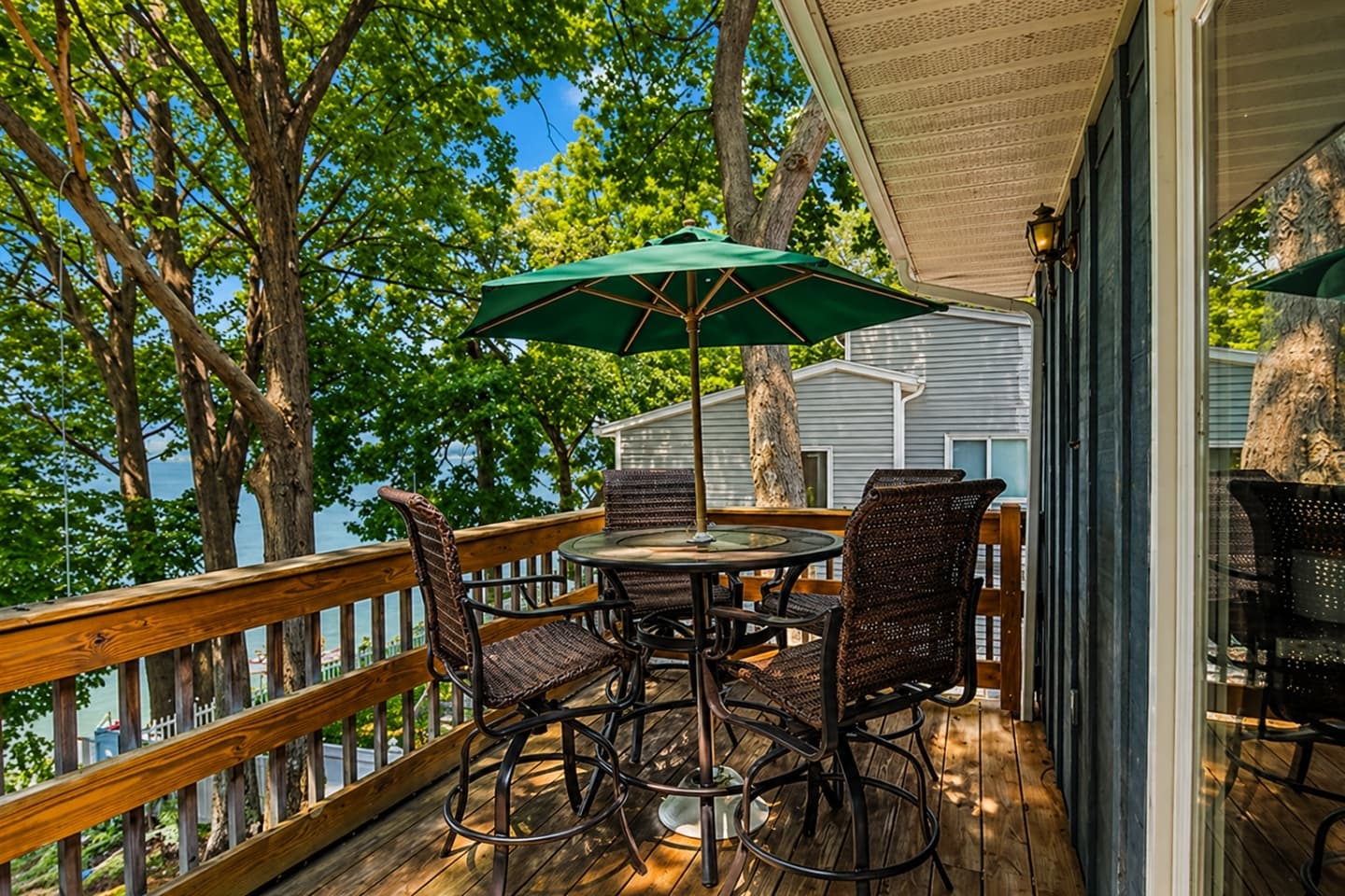 Deck seating beneath green umbrella
