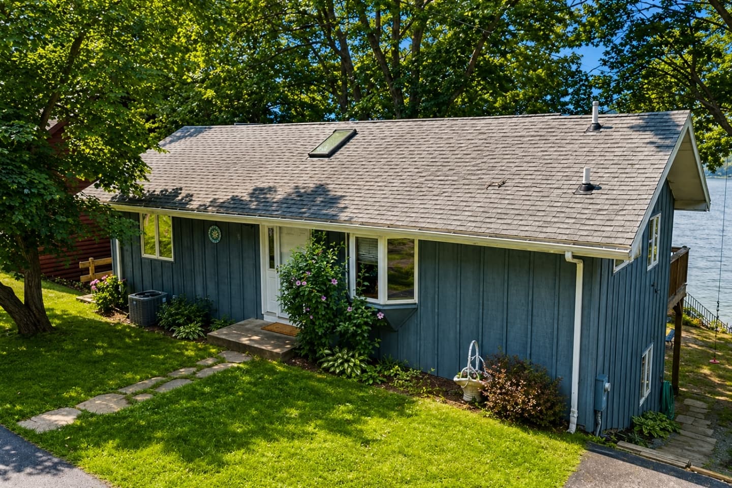 Cottage exterior beneath the tree canopy