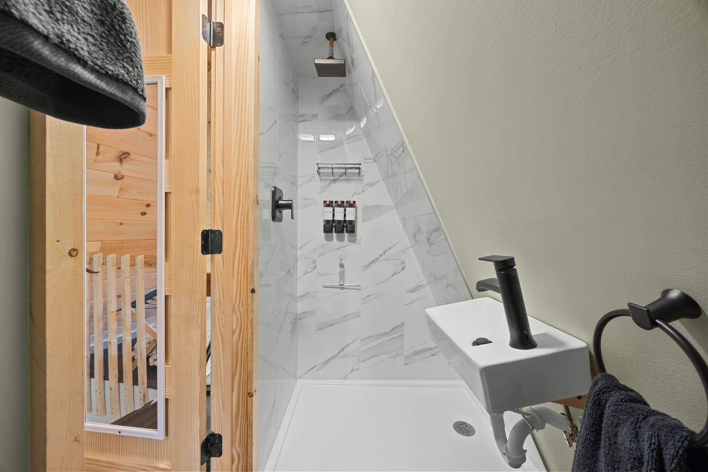 Small bathroom with shower on the second floor loft.