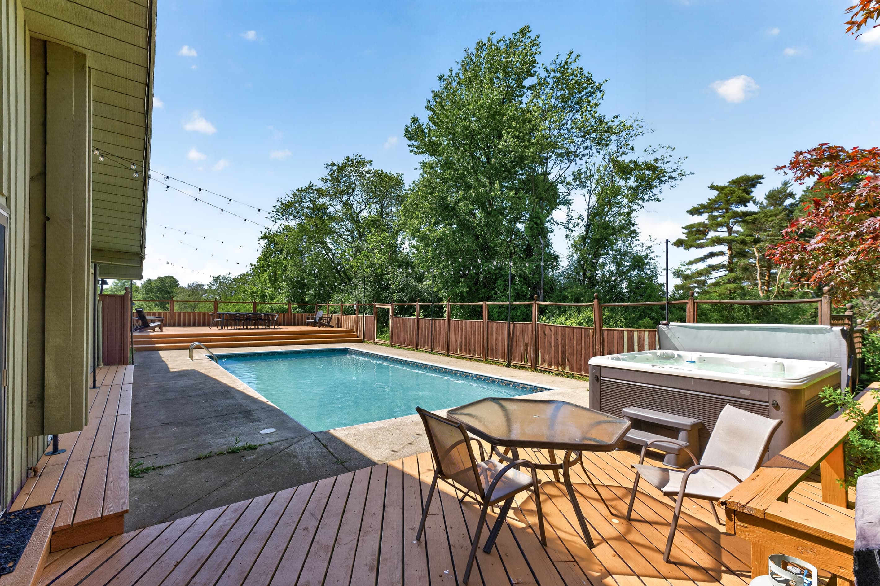 In-ground pool beside the furnished deck
