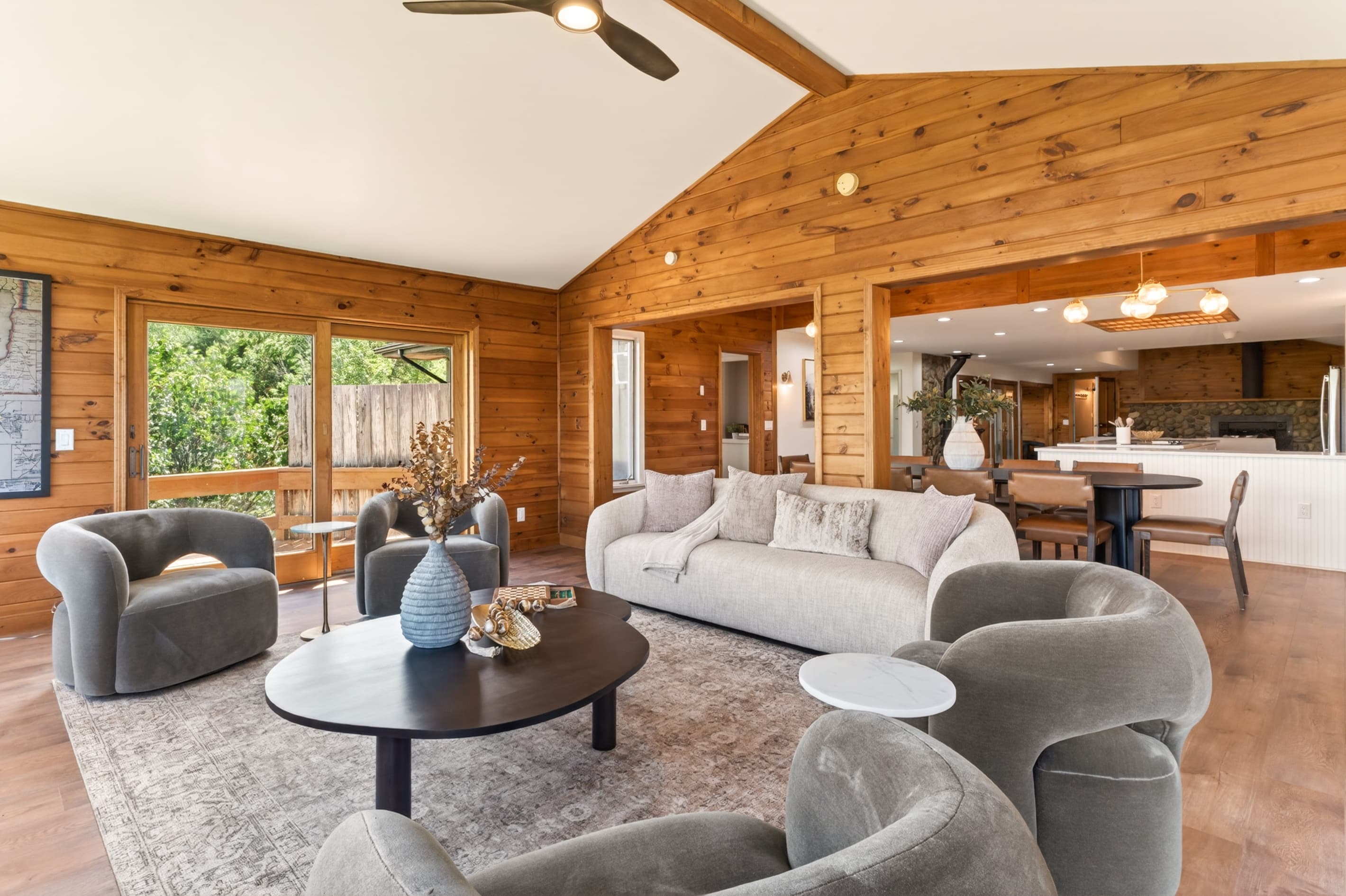 Living room with layered seating and wood walls