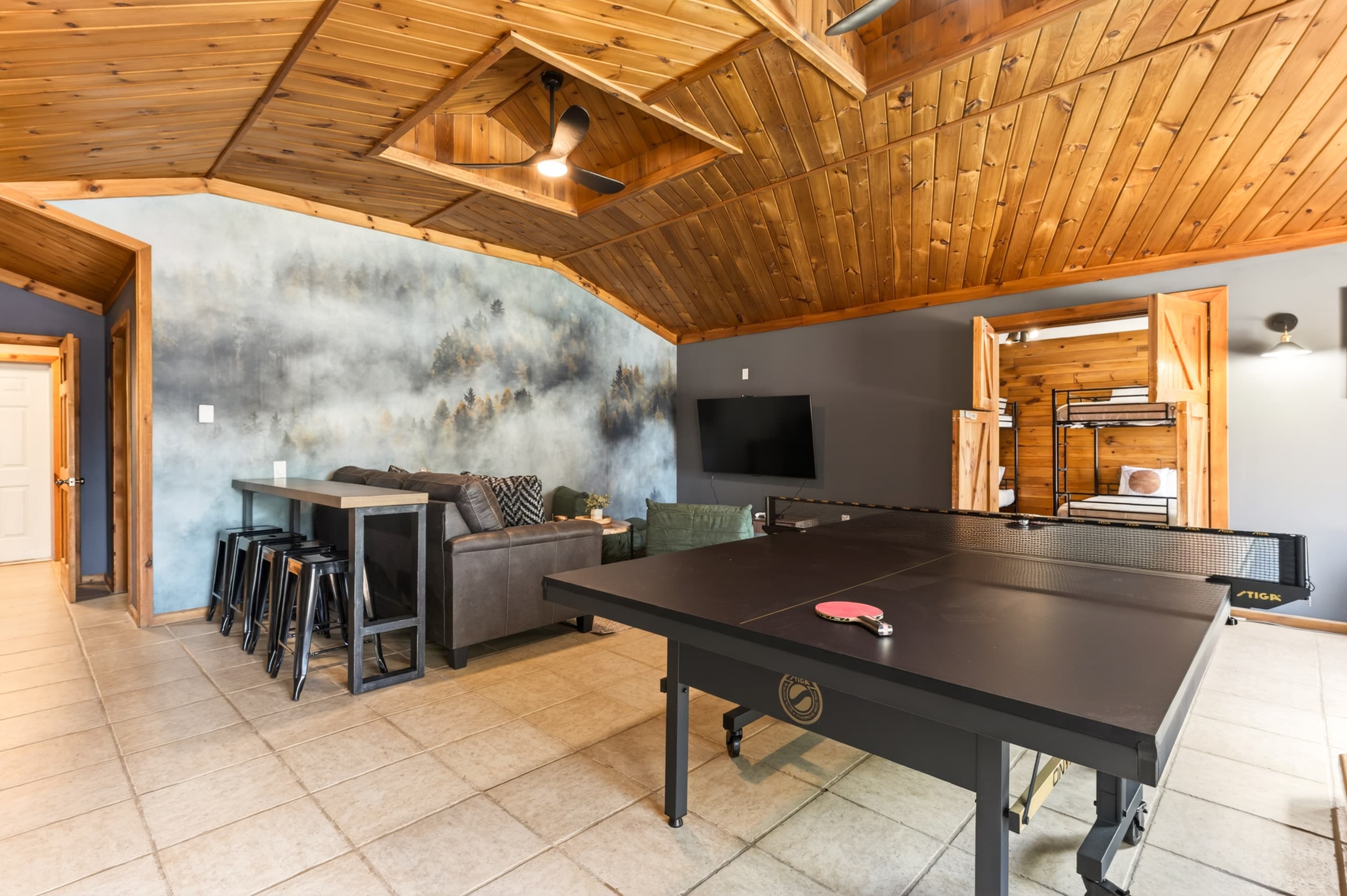 Game room with television and sectional seating