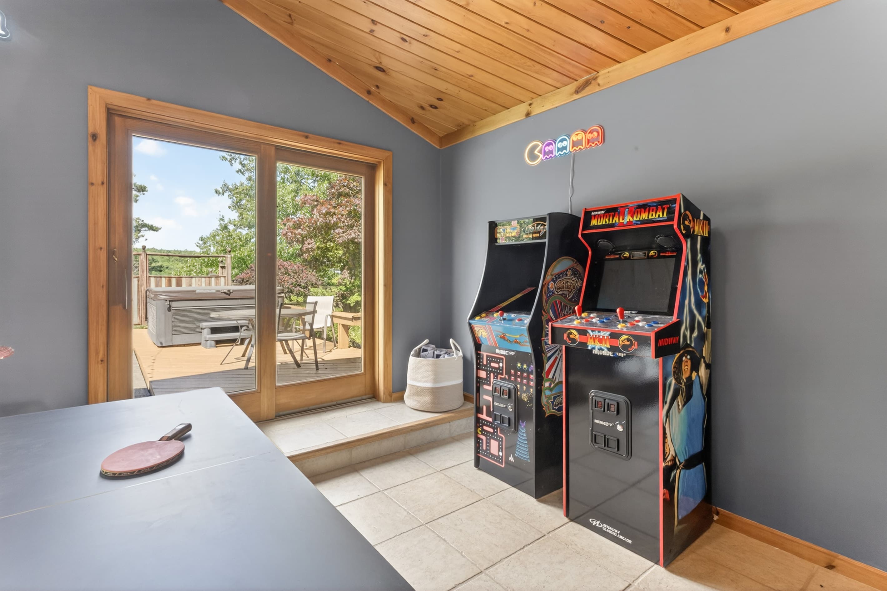 Arcade games beside a large window