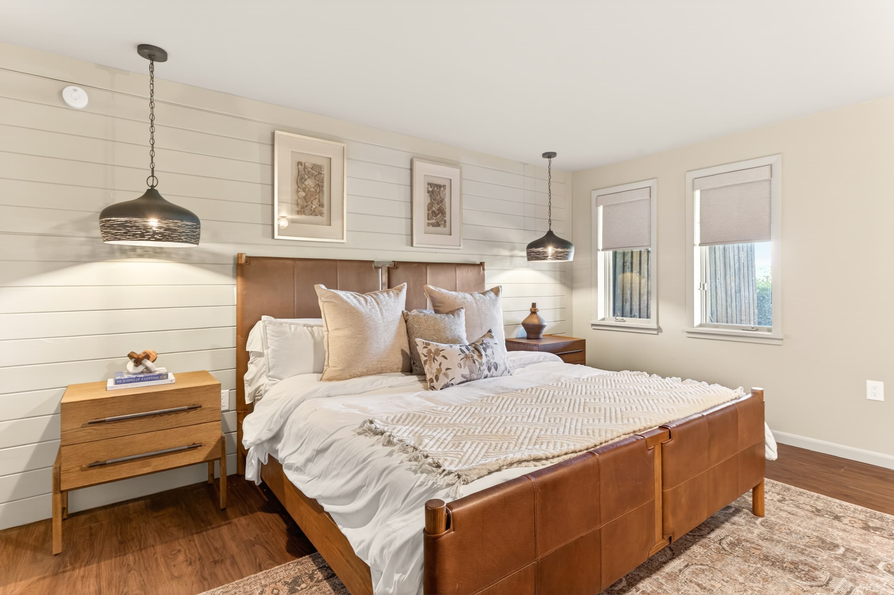 Bedroom with wood-framed bed and bench