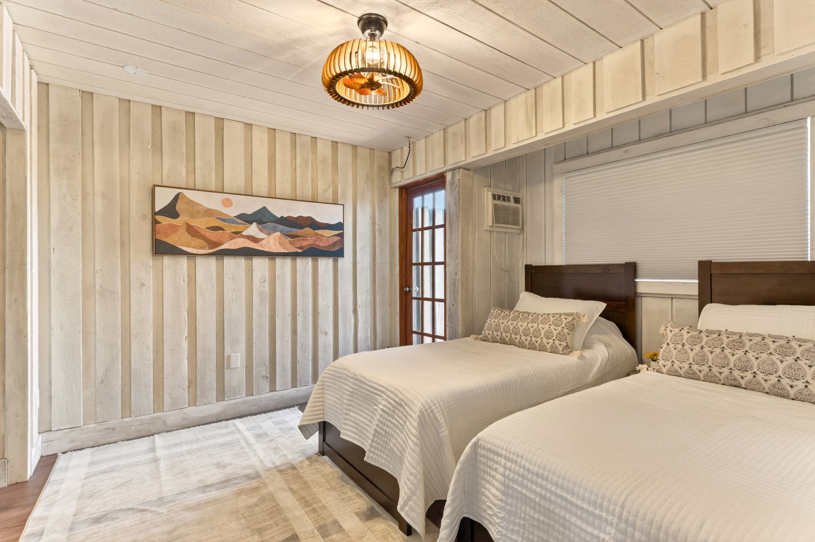 Vaulted bedroom with multiple beds