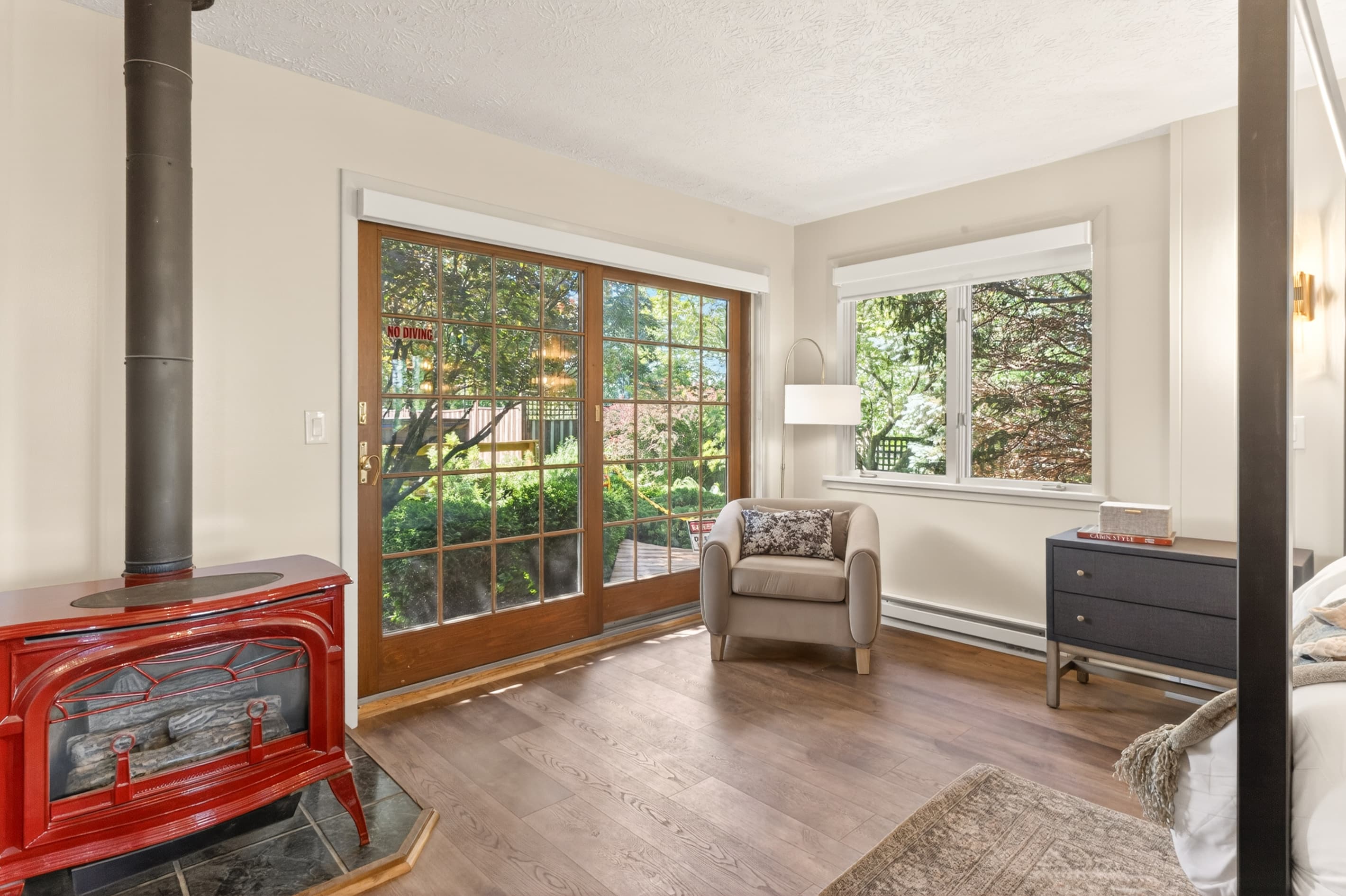 Windowed bedroom with dresser and seating