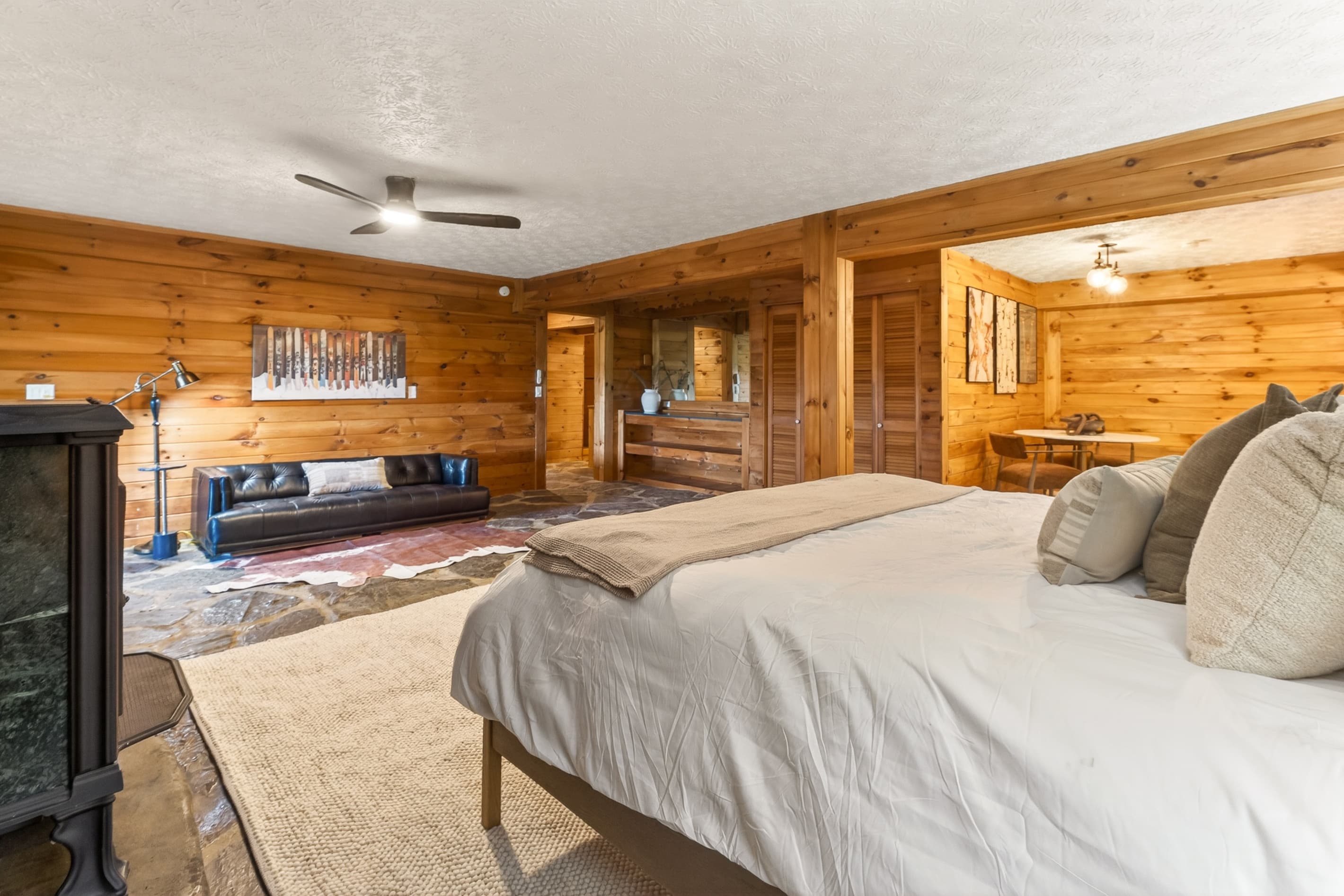 Wood-paneled bedroom with a leather couch