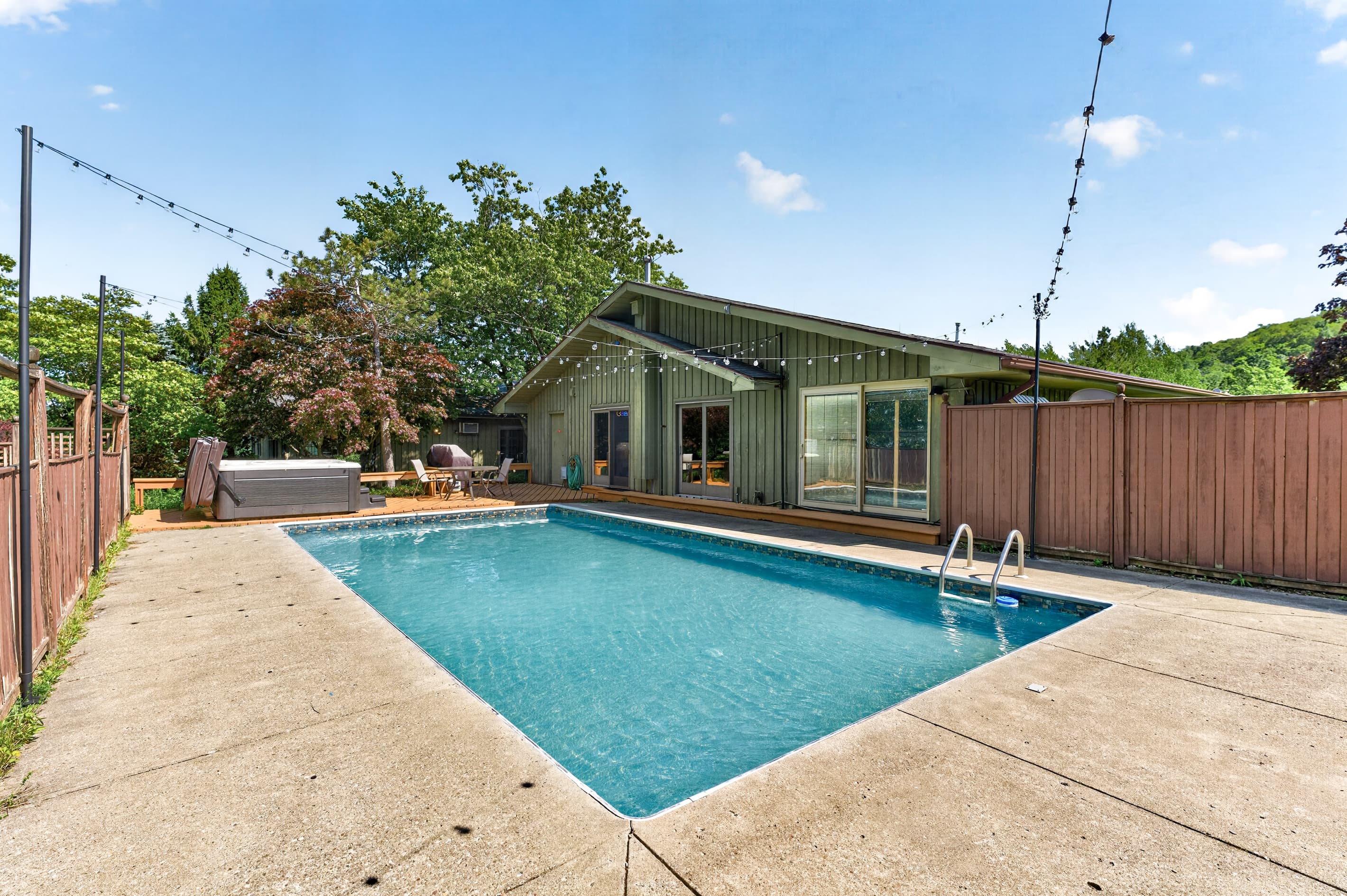 Outdoor pool surrounded by concrete decking