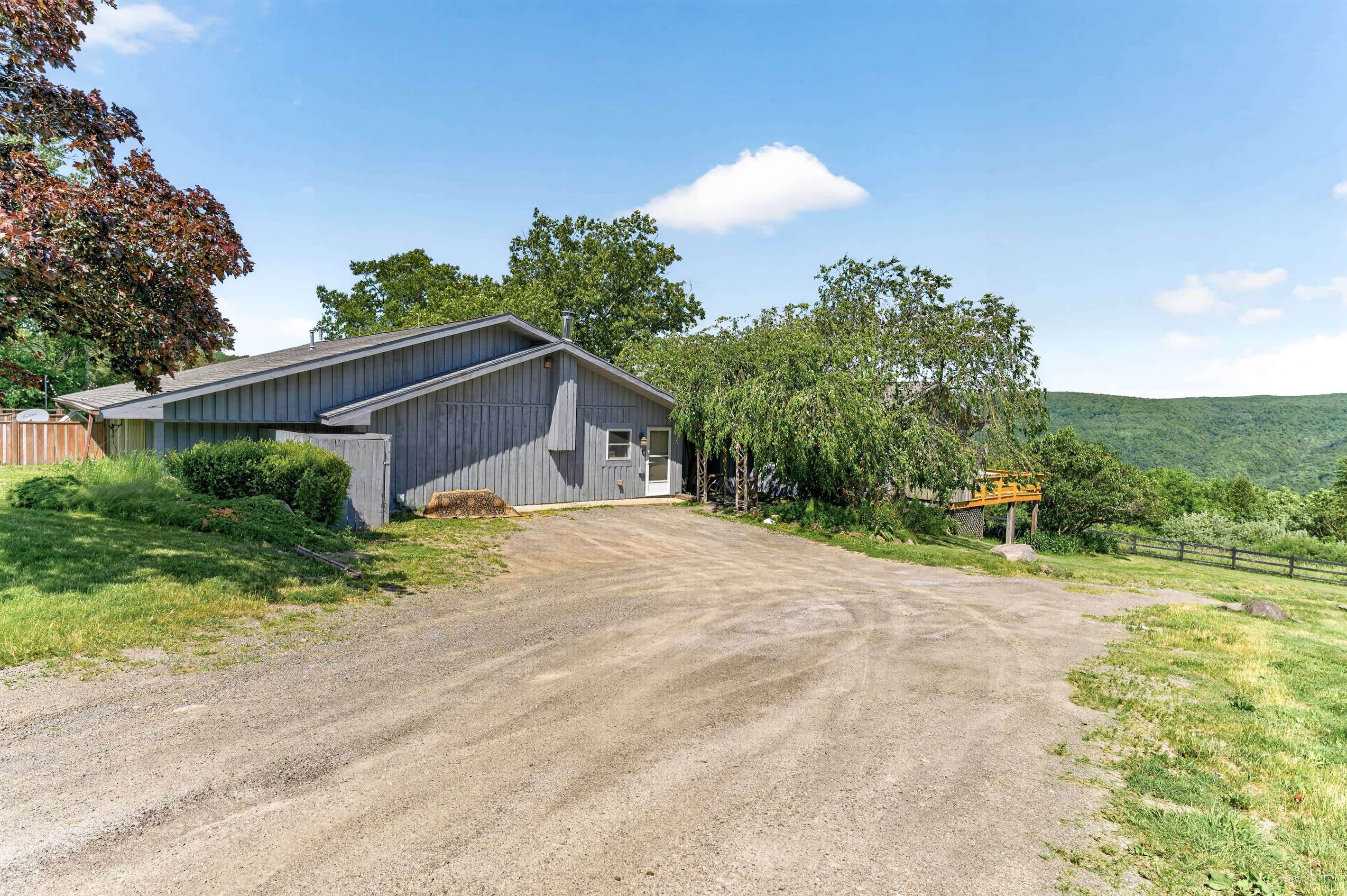 Gravel driveway leading toward the house