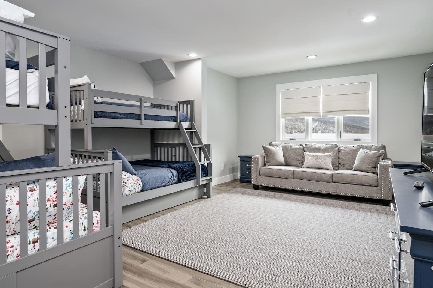 Bunk room with additional sofa seating