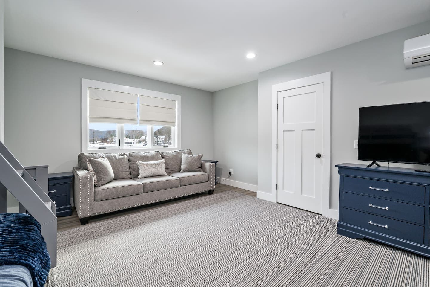 Lower-level lounge with sofa and television