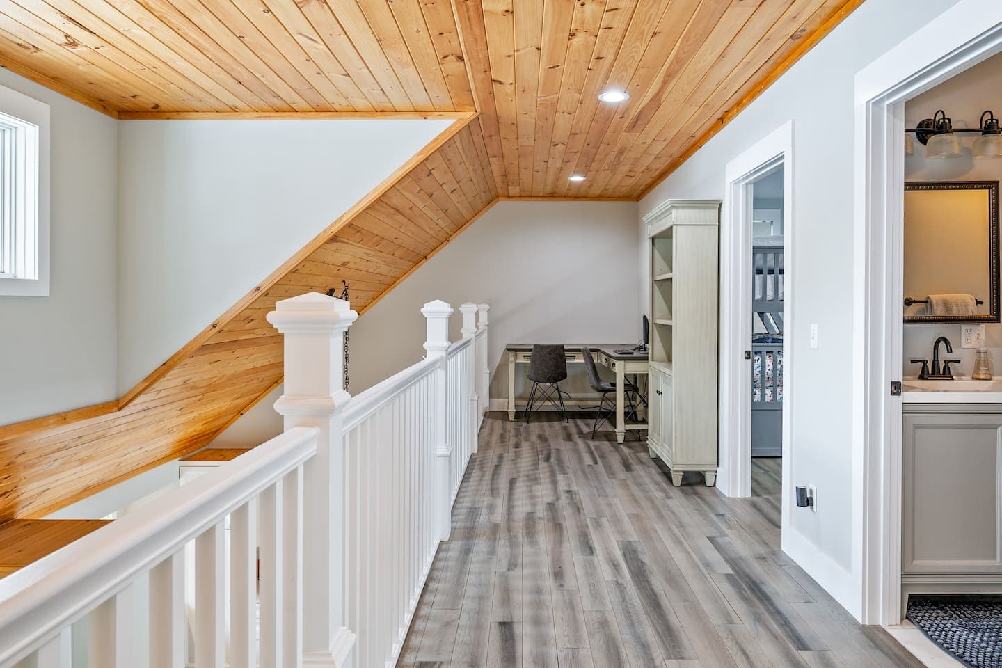 Loft hallway with wood-paneled ceiling
