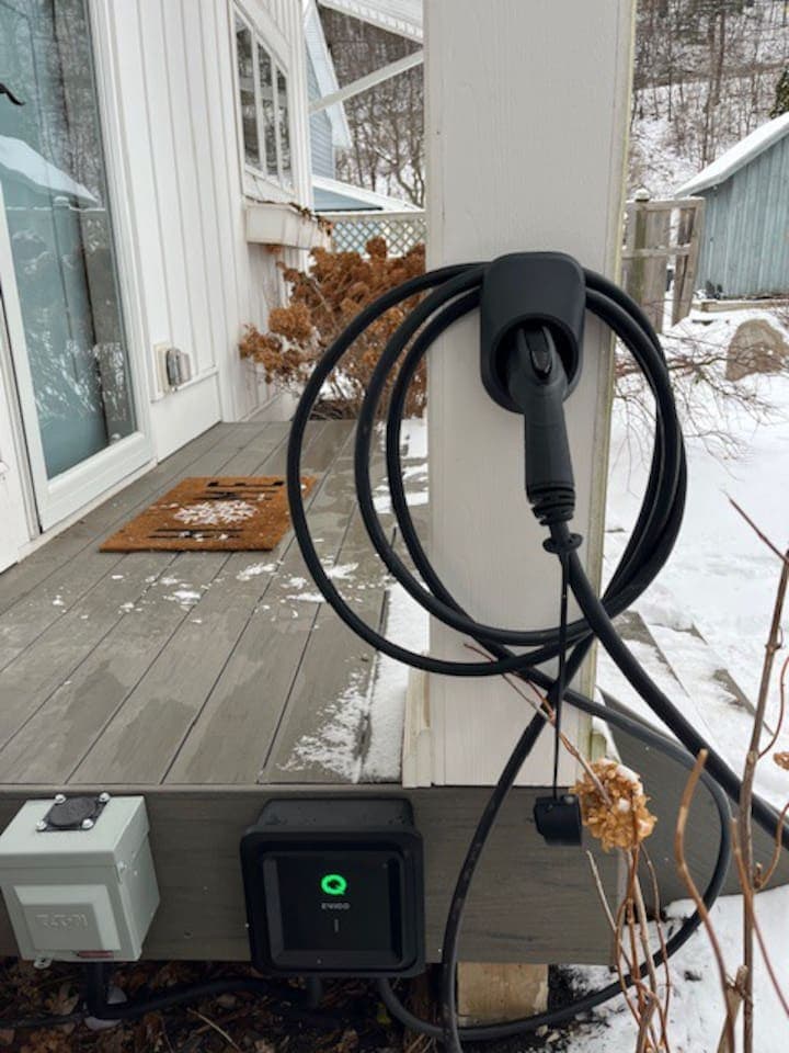 Electric vehicle charger mounted outdoors