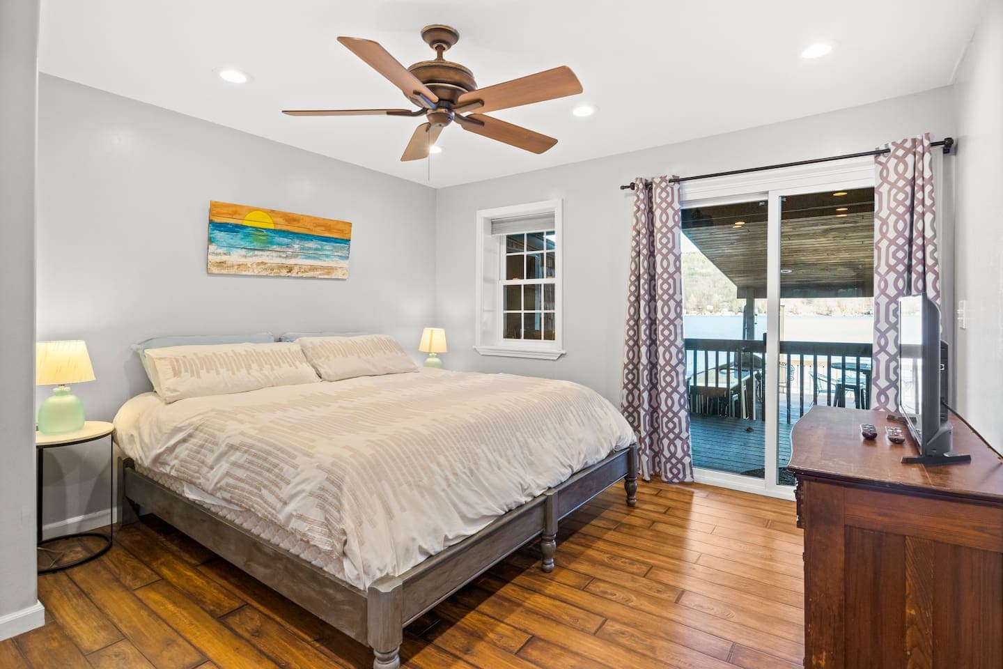 Bedroom with ceiling fan and balcony access